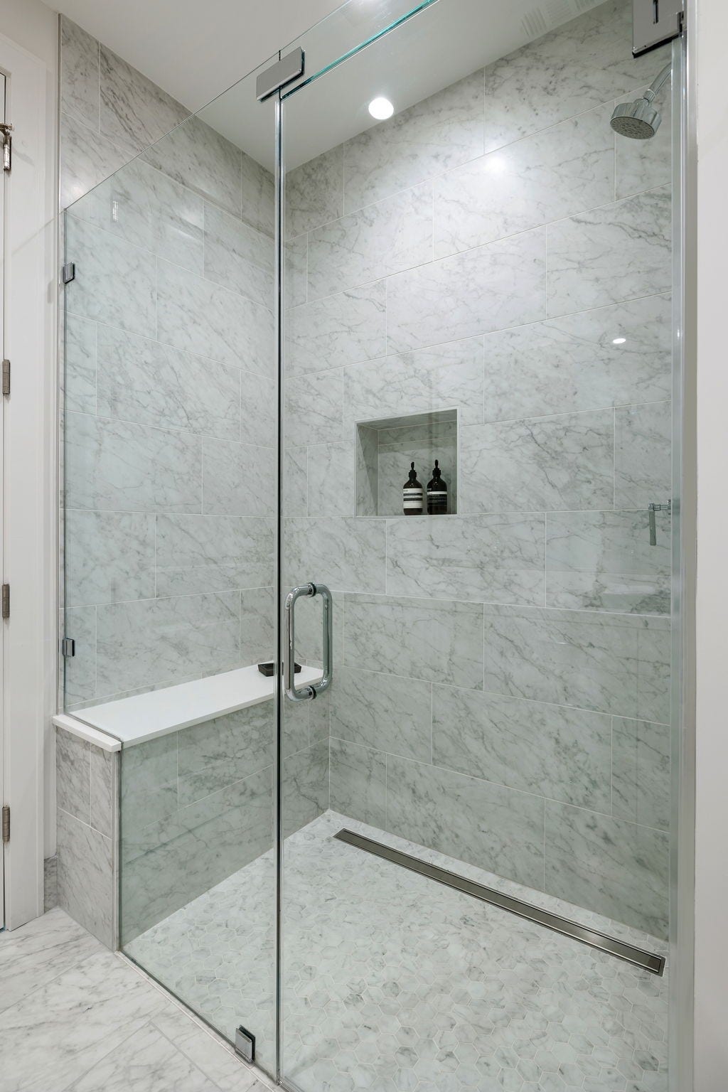 5656 San Felipe Street, #1005, Houston, TX 77056 Secondary guest bathroom with glass-framed walk-in shower. Photos are of a similar unit with the same floor plan