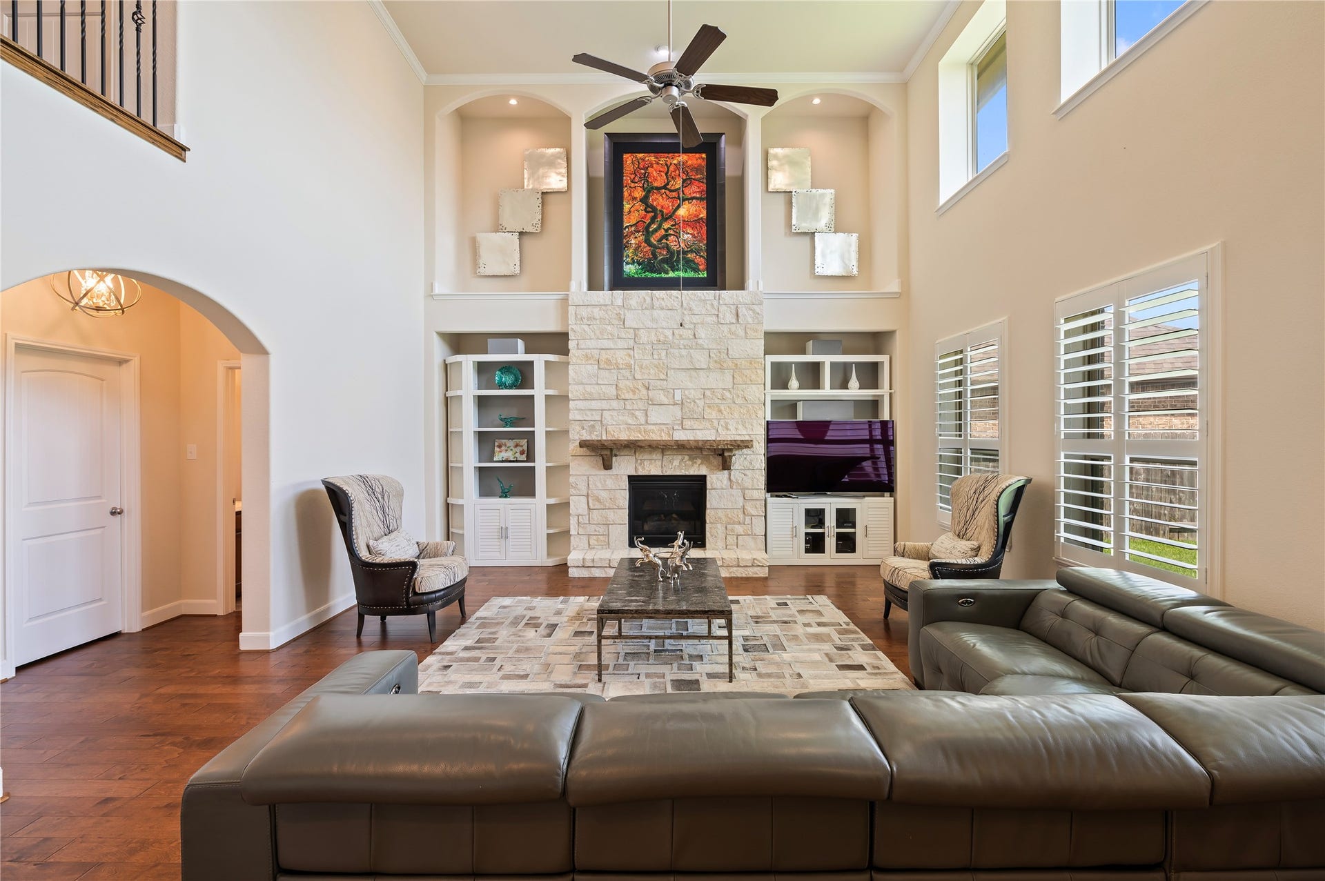 2322 Ashley Falls Lane, League City, TX 77573 The stacked stone remote gas fireplace is the focal point of the family room with crown molding and art niches, while plantation shutters provide classic style and privacy.