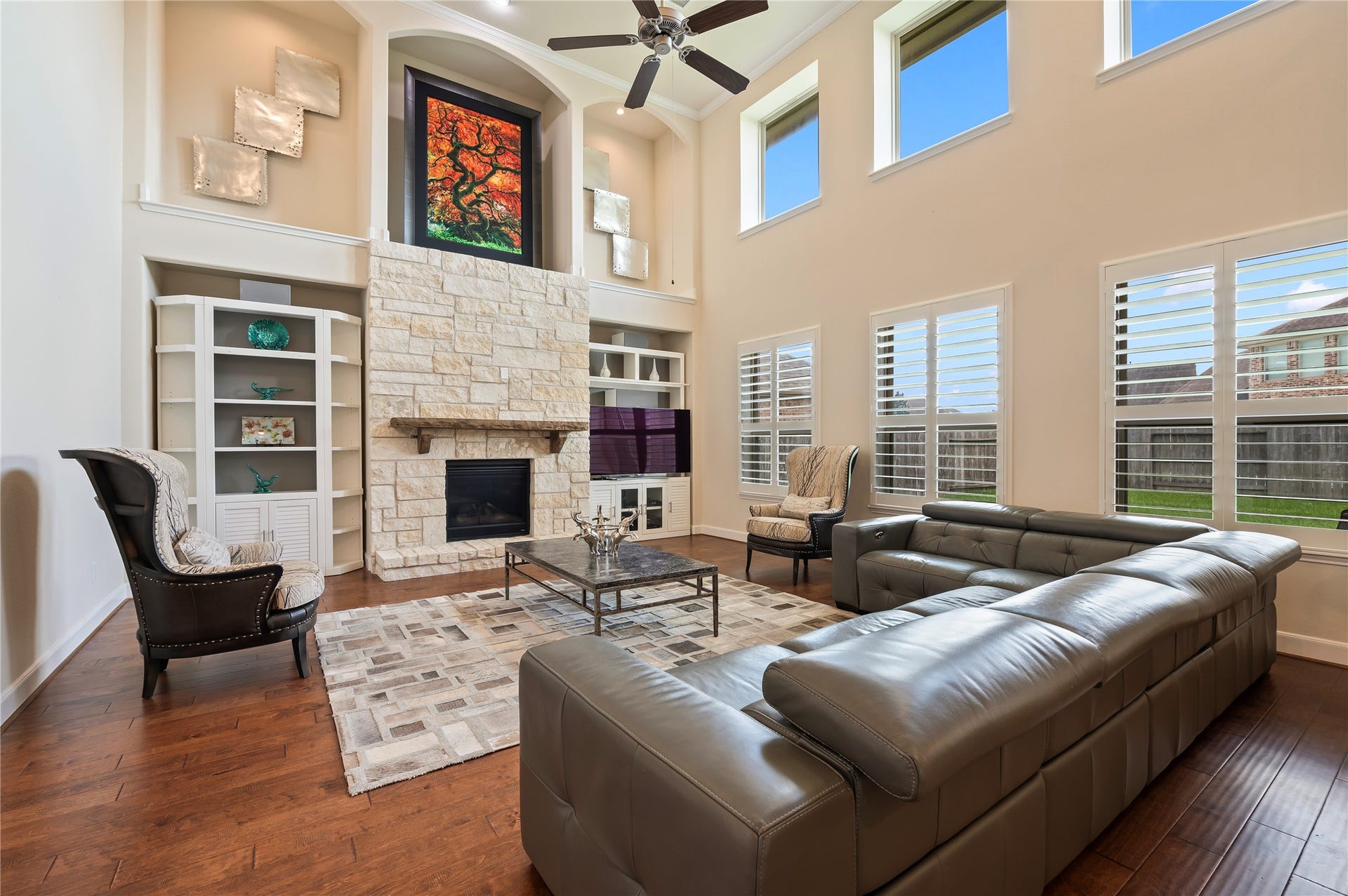 2322 Ashley Falls Lane, League City, TX 77573 Family room features floor-to-ceiling windows, creating a light, open atmosphere throughout the home. Rich solid hardwood flooring adds timeless warmth and sophistication.