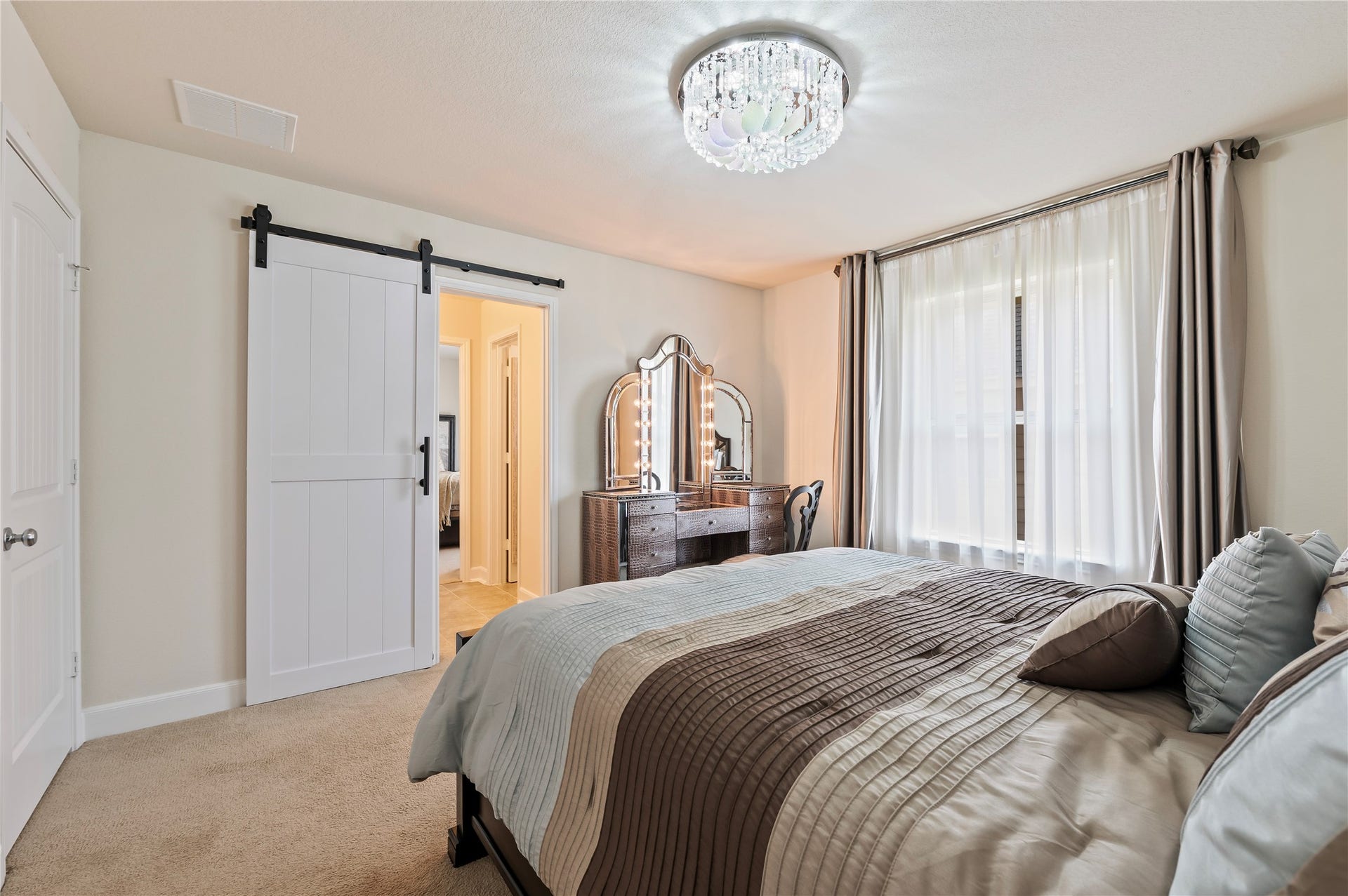 2322 Ashley Falls Lane, League City, TX 77573 4th bedroom upstairs with custom light fixtures, walk-in closet and custom sliding barn doors leading to Jack-n-Jill bathroom.