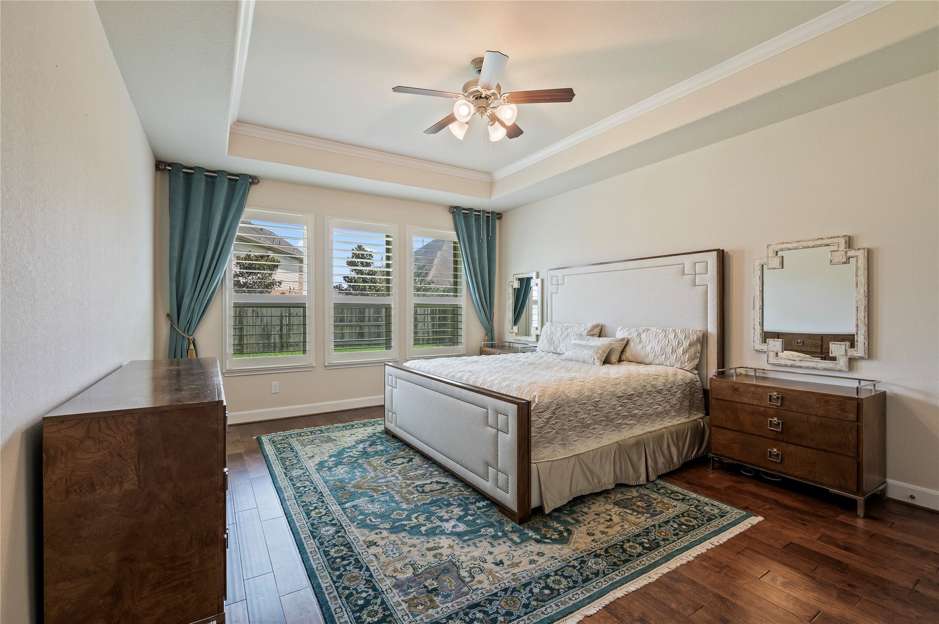 2322 Ashley Falls Lane, League City, TX 77573 Luxurious primary suite showcasing rich hardwood floors, crown molding and plantation shutters.