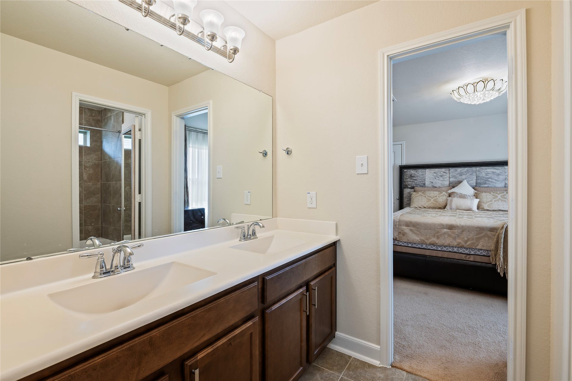 2322 Ashley Falls Lane, League City, TX 77573 Jack-n-Jill 4th full bathroom features double sinks and private door leading to the tub/shower combo. Ceramic tile and grout recently professionally cleaned upon seller's move out.