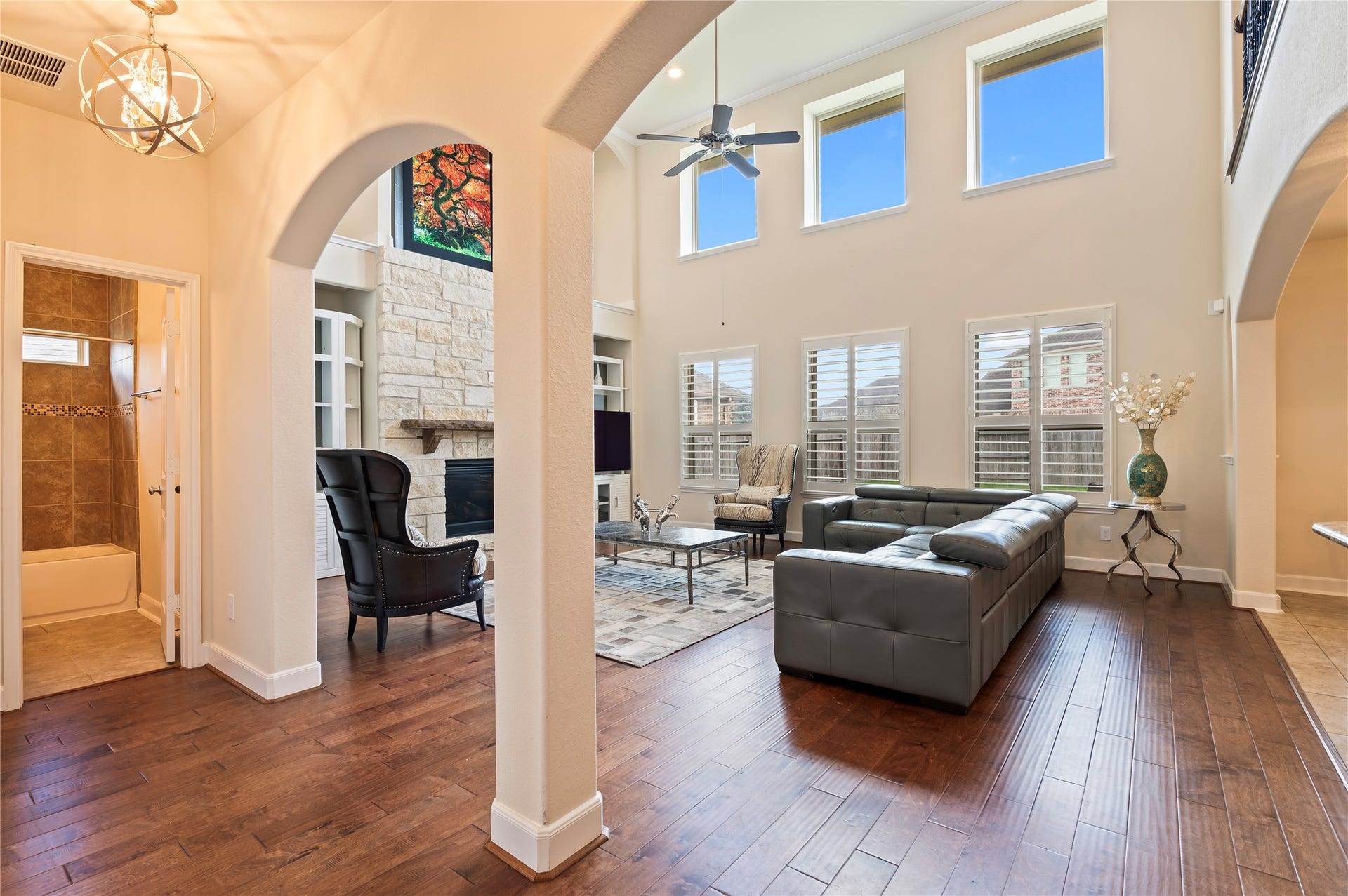 2322 Ashley Falls Lane, League City, TX 77573 The hardwood floors flow seamlessly into the spacious family room with archways leading to the second bedroom and full bathroom downstairs.