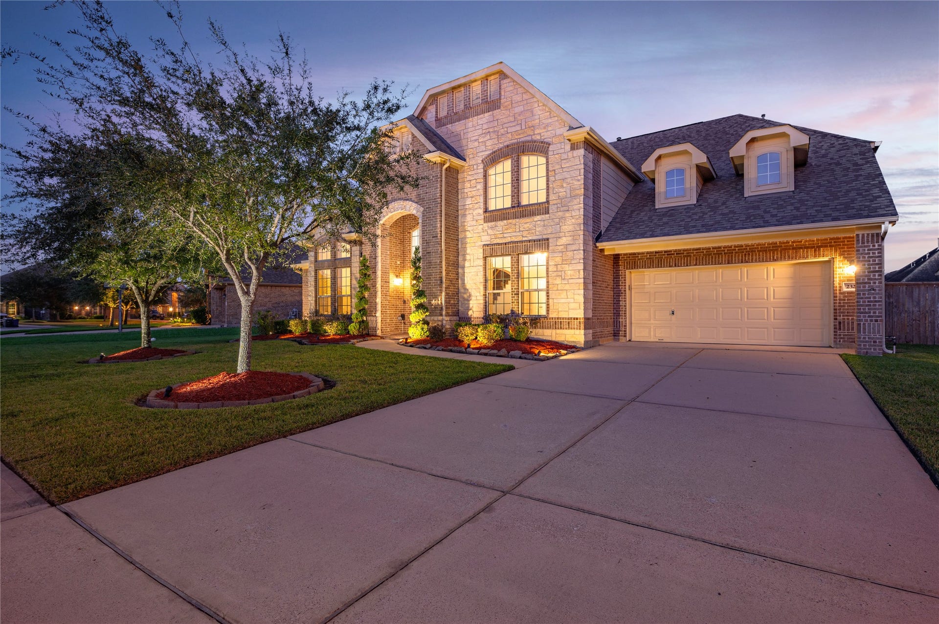 2322 Ashley Falls Lane, League City, TX 77573 Double wide driveway with spacious 3-car garage provides ample room for vehicles, storage, or a workshop.