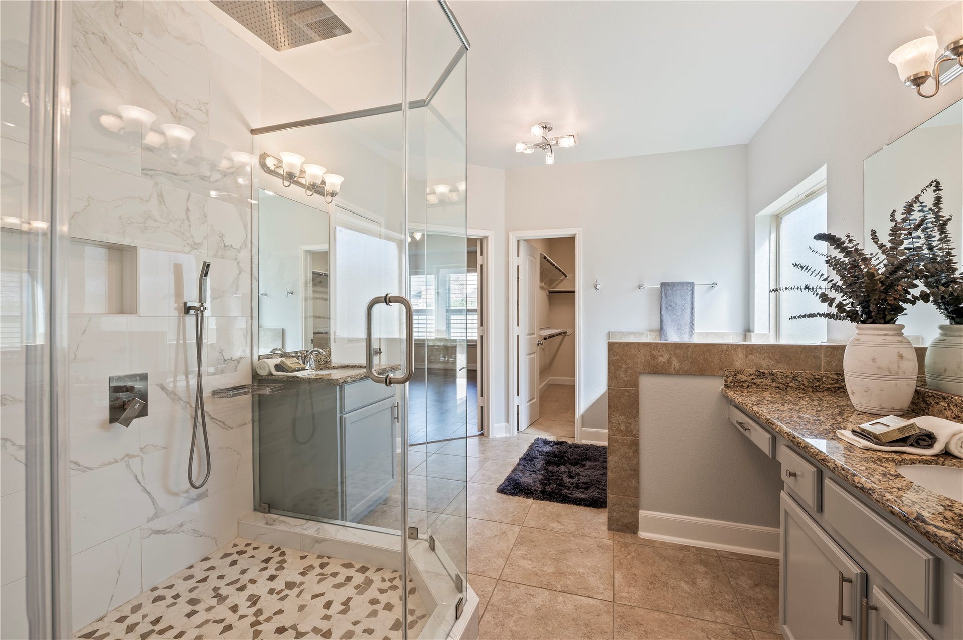 2322 Ashley Falls Lane, League City, TX 77573 Spectacularly updated 6'x4' seamless glass shower featuring dual rainfall shower heads and removable handheld wands with river rock accented flooring.