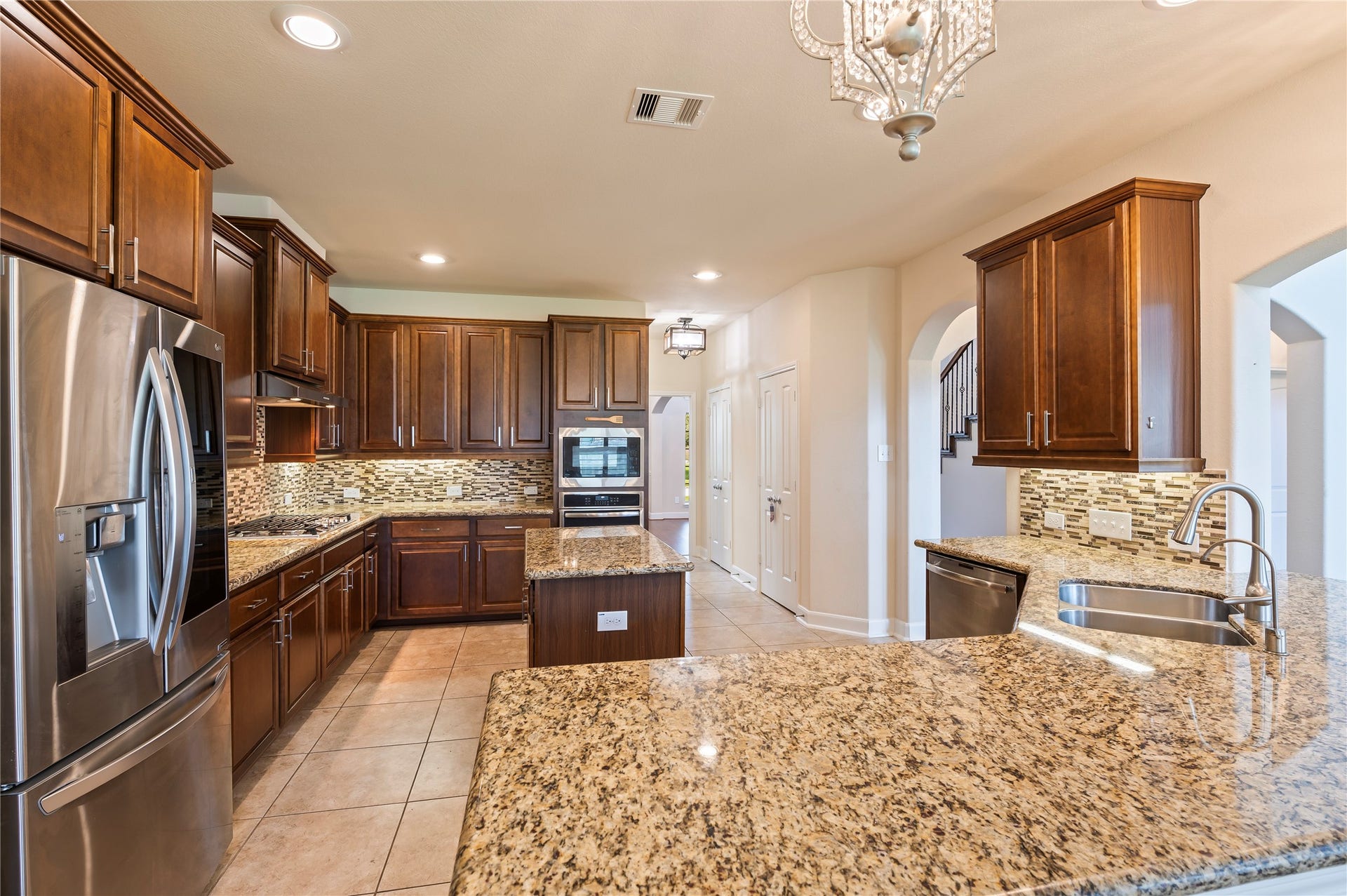 2322 Ashley Falls Lane, League City, TX 77573 Well appointed kitchen features gorgeous granite countertops, wrap-around breakfast bar and under cabinet lighting.