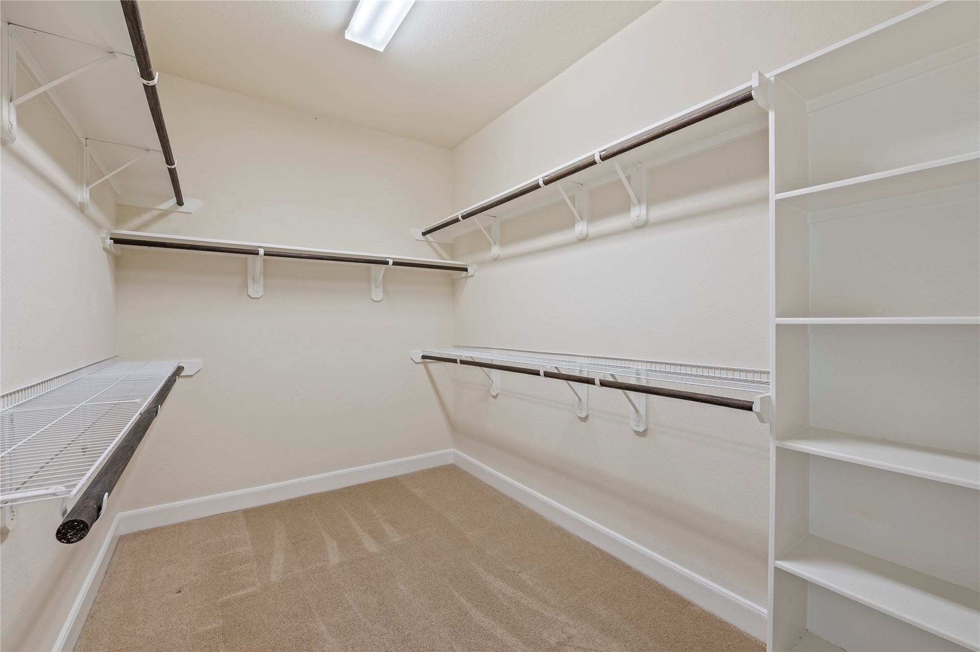 2322 Ashley Falls Lane, League City, TX 77573 His and hers walk-in closet with built-in storage.