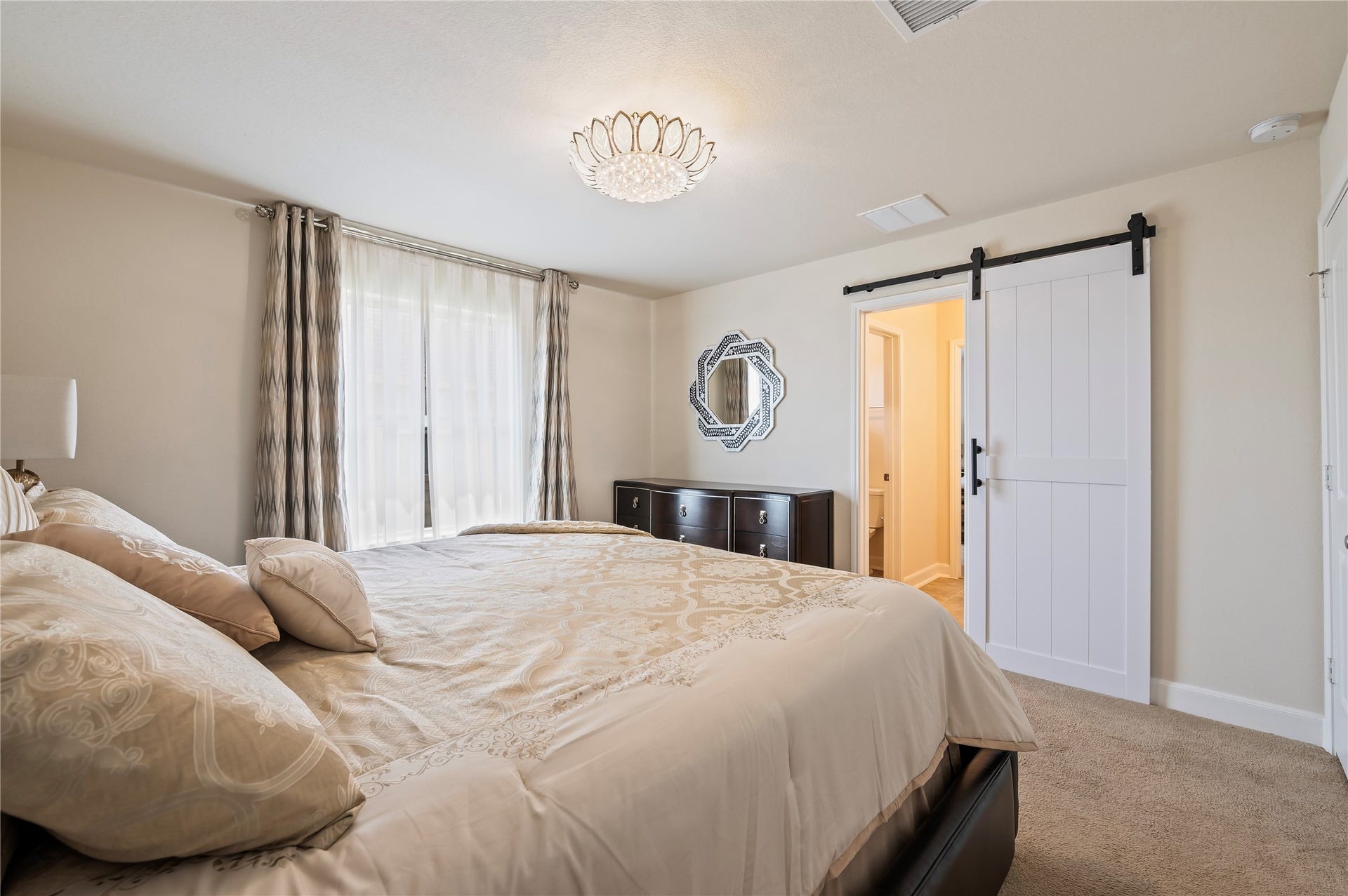 2322 Ashley Falls Lane, League City, TX 77573 5th bedroom upstairs with custom light fixtures, walk-in closet and custom sliding barn doors leading to Jack-n-Jill bathroom.