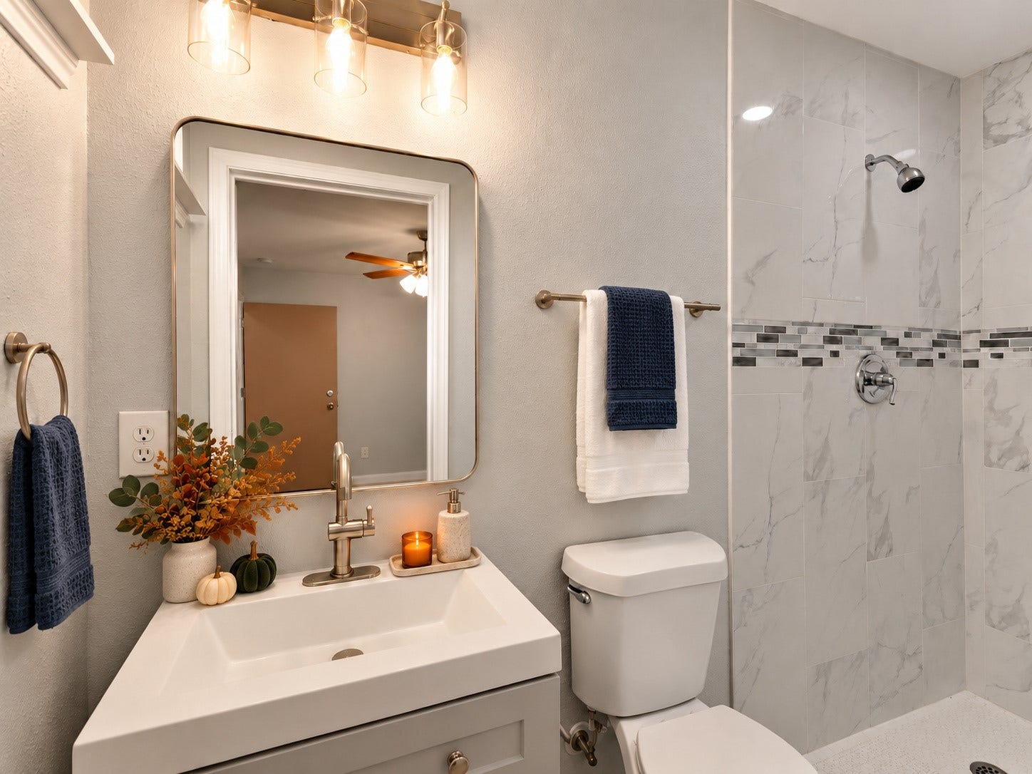 9827 Shive Drive, Houston, TX 77078 Updated bathroom featuring a tiled walk-in shower with a decorative accent, a modern vanity, and framed mirror. Digitally staged.