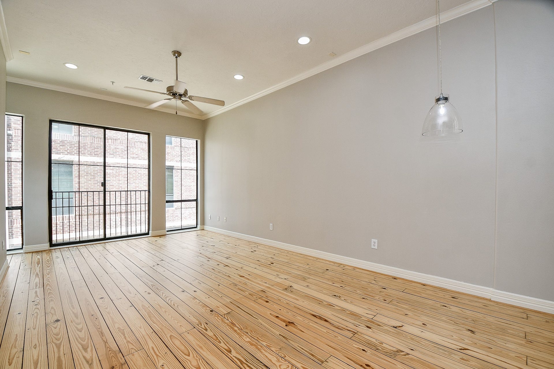 118 McGowen Street, #K, Houston, TX 77006 Beautiful Pine wood floors in the living room with high ceilings cannister lights and lots of natural light