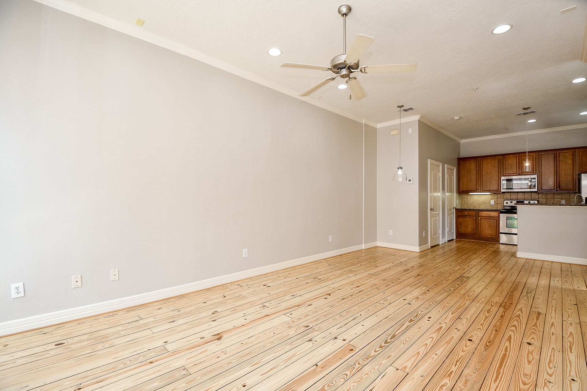 118 McGowen Street, #K, Houston, TX 77006 True open concept design with beautiful Pine wood floors in the living room with high ceilings cannister lights and lots of natural light