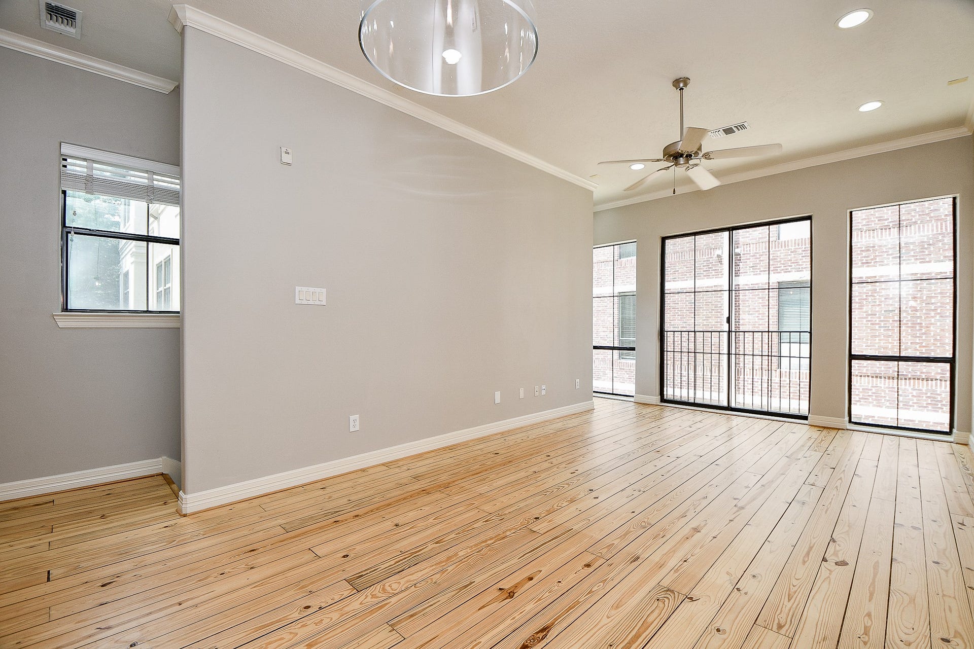 118 McGowen Street, #K, Houston, TX 77006 Beautiful Pine wood floors in the living room with high ceilings cannister lights and lots of natural light