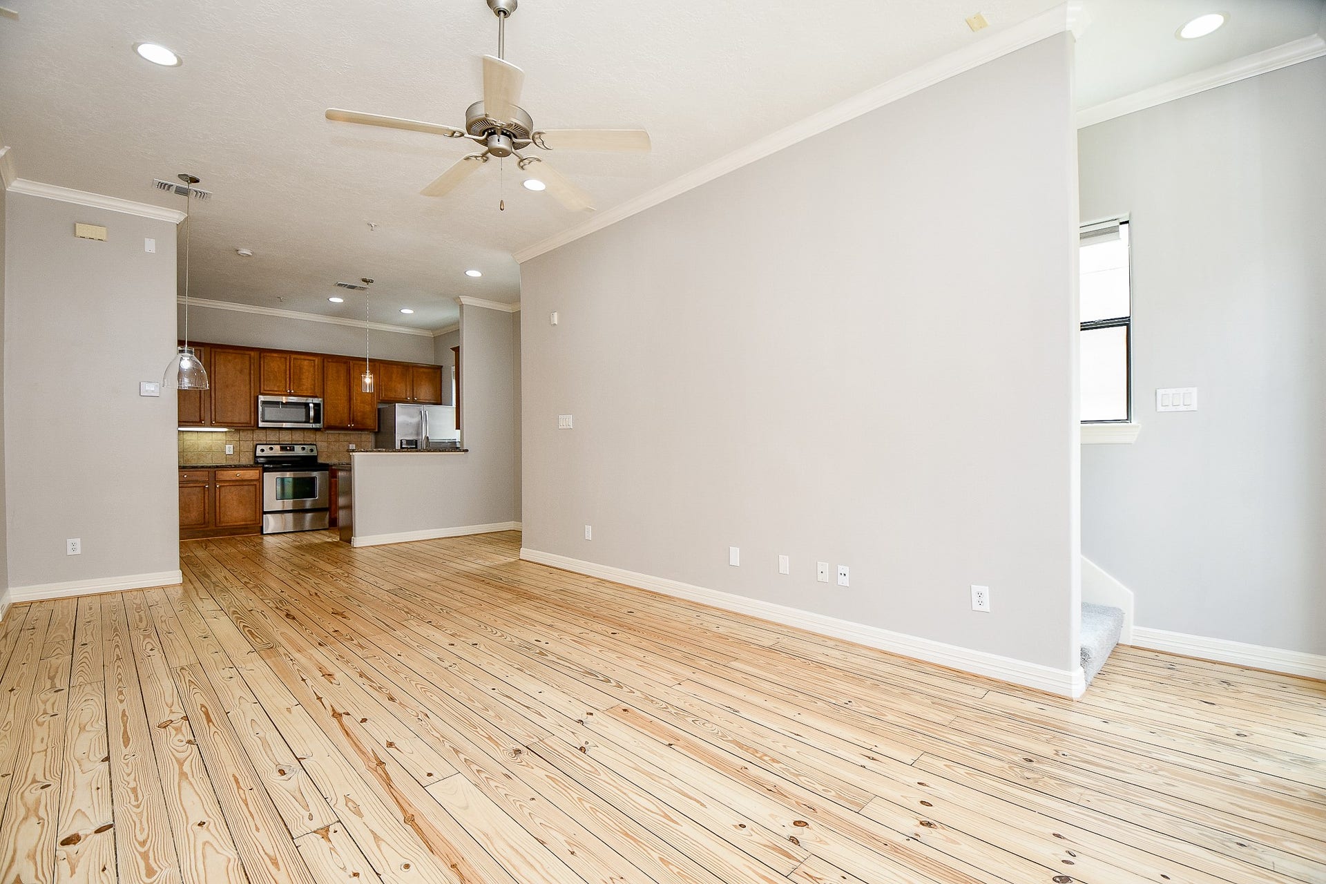 118 McGowen Street, #K, Houston, TX 77006 True open concept design with beautiful Pine wood floors in the living room with high ceilings cannister lights and lots of natural light