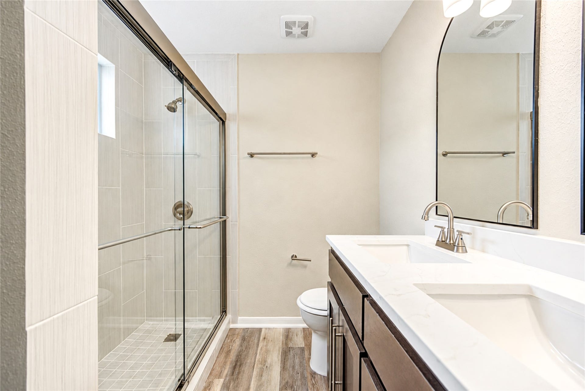15106 Cypress Green Drive, Cypress, TX 77429 Redesigned primary shower featuring large-format porcelain tile, glass mosaic accents and new glass enclosure.
