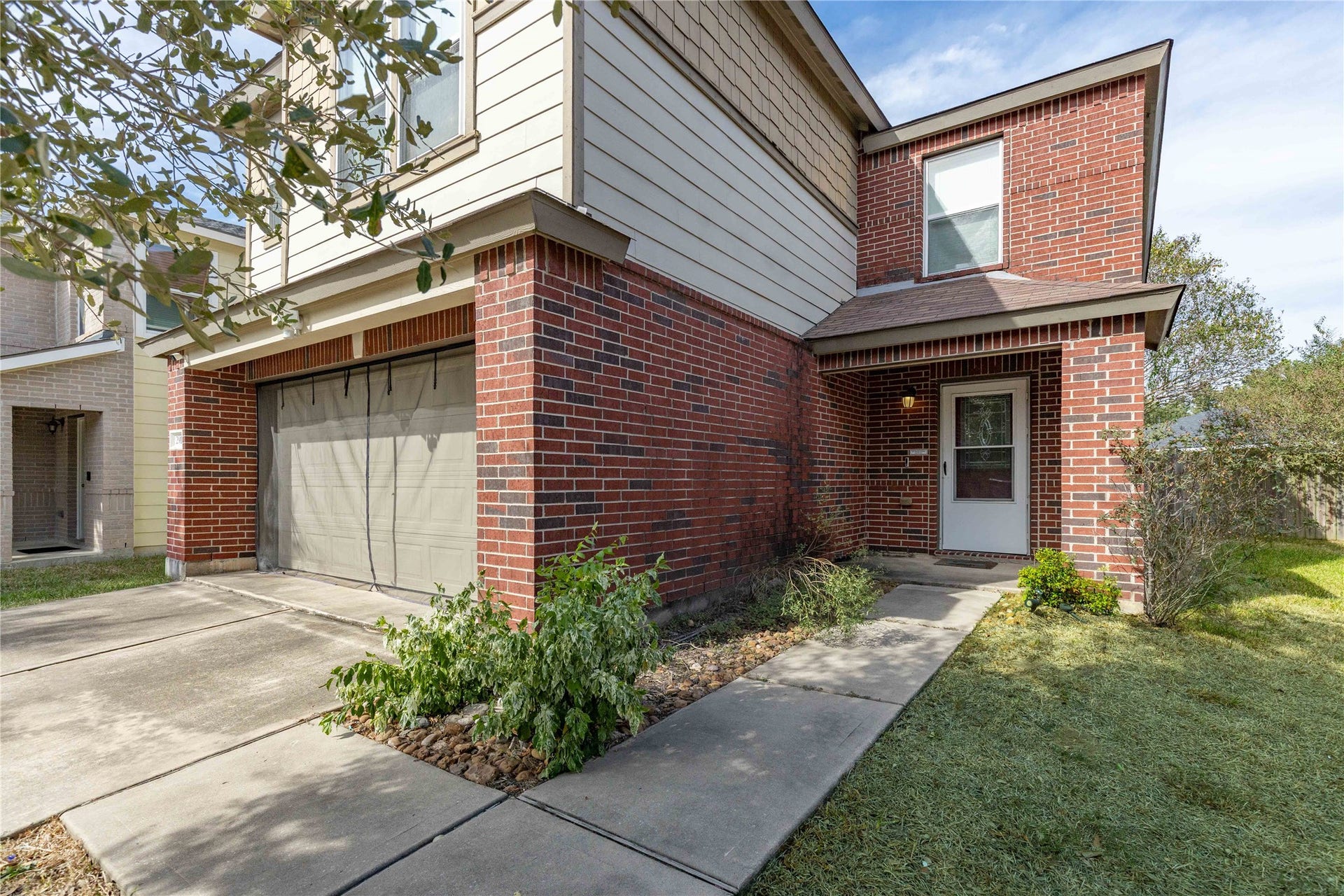 2910 Ribbon Creek Way, Spring, TX 77389 Charming two-story home featuring a combination of brick and siding exterior, with a welcoming front entrance and attached garage.