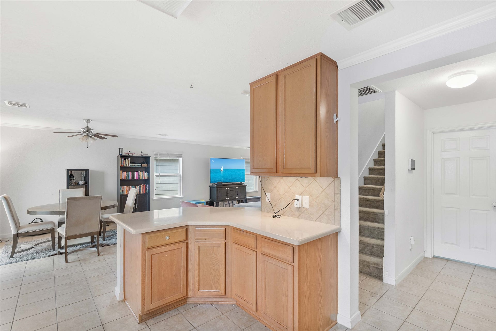 2910 Ribbon Creek Way, Spring, TX 77389 Spacious open-concept living area features a modern kitchen with ample cabinetry, flowing seamlessly into a bright dining space and cozy living room, perfect for family gatherings.
