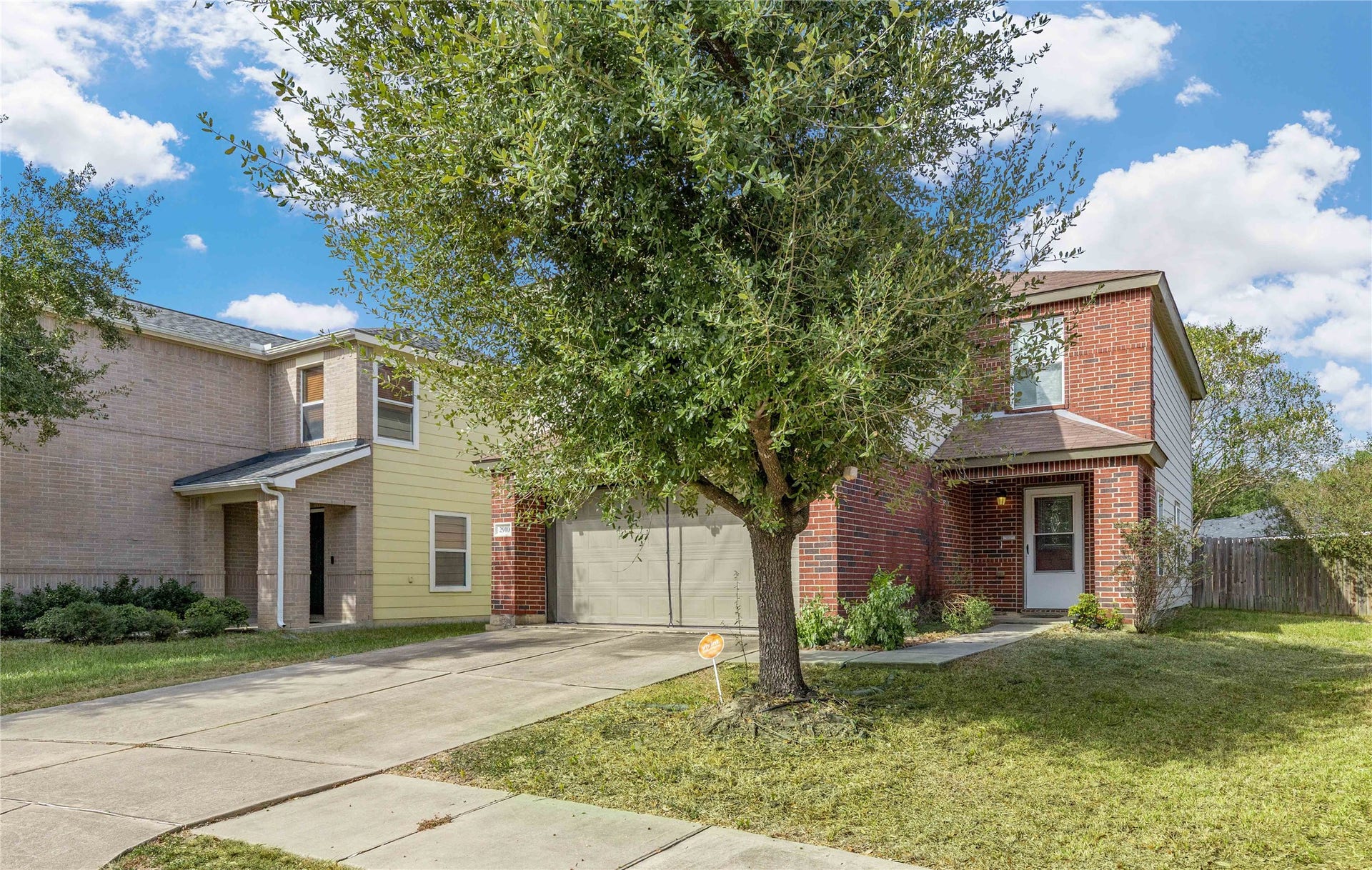 2910 Ribbon Creek Way, Spring, TX 77389 Charming two-story brick home with a front-facing garage and a well-maintained lawn, nestled in a peaceful neighborhood.
