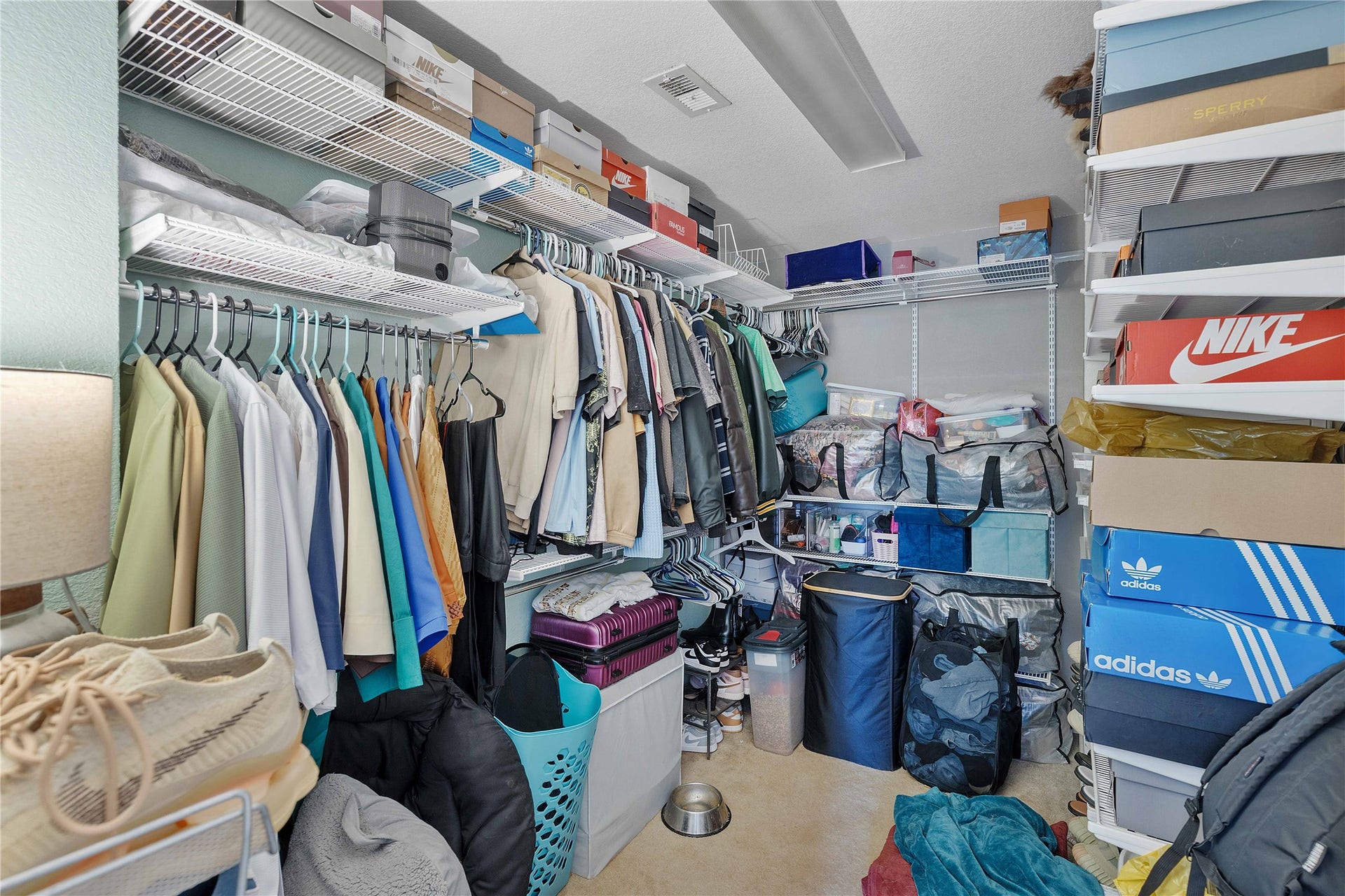 2910 Ribbon Creek Way, Spring, TX 77389 Spacious walk-in closet with organized shelving and ample hanging space, perfect for storing clothing and shoes.