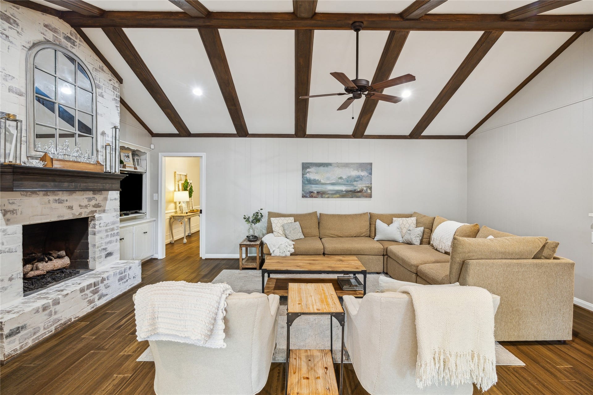 10714 Piping Rock Lane, Houston, TX 77042 Wood flooring, recessed lighting and a brick fireplace create a comfortable setting for gathering or relaxing.