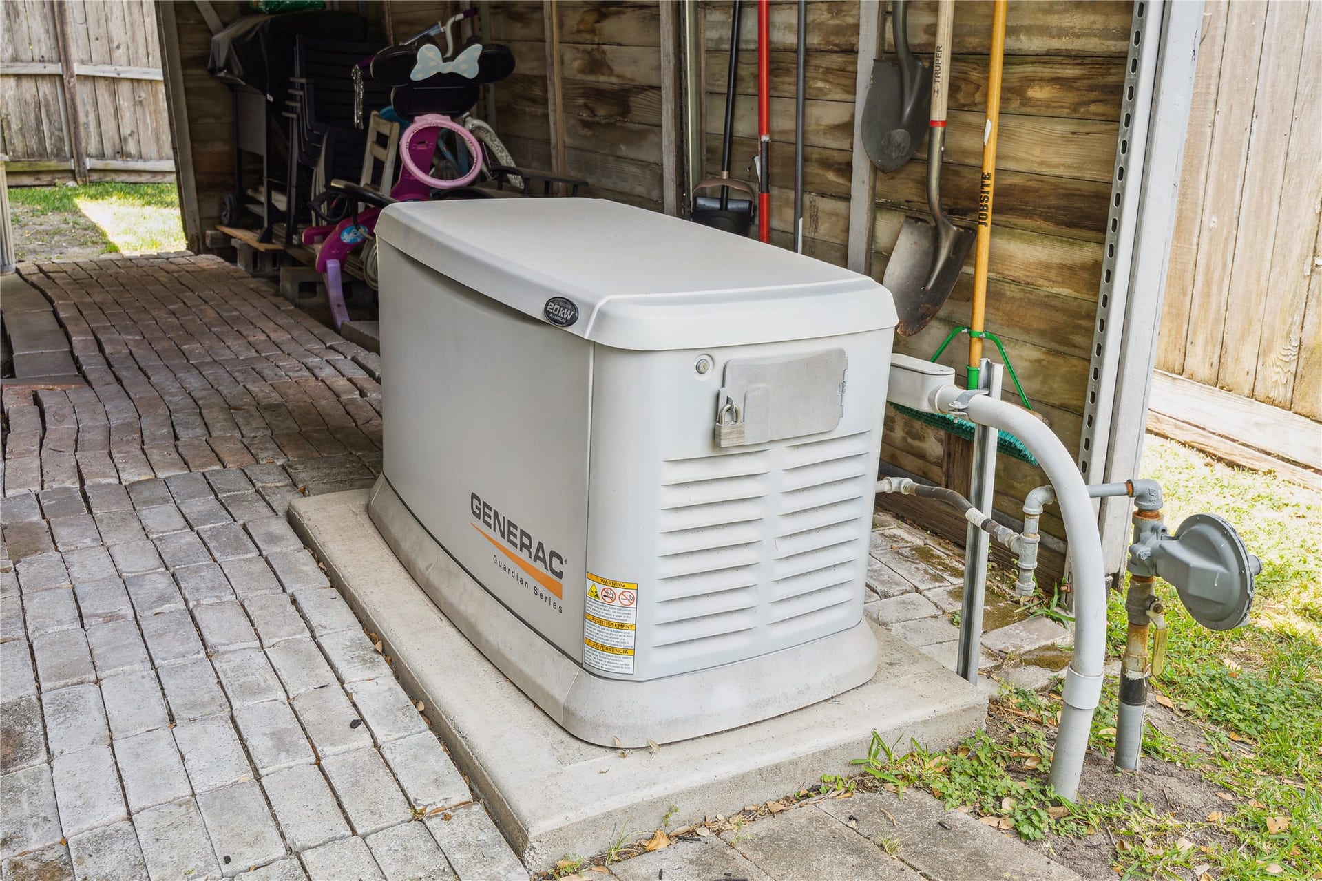 10714 Piping Rock Lane, Houston, TX 77042 A Generac standby generator is positioned beside the home, adding a valuable feature for backup power.