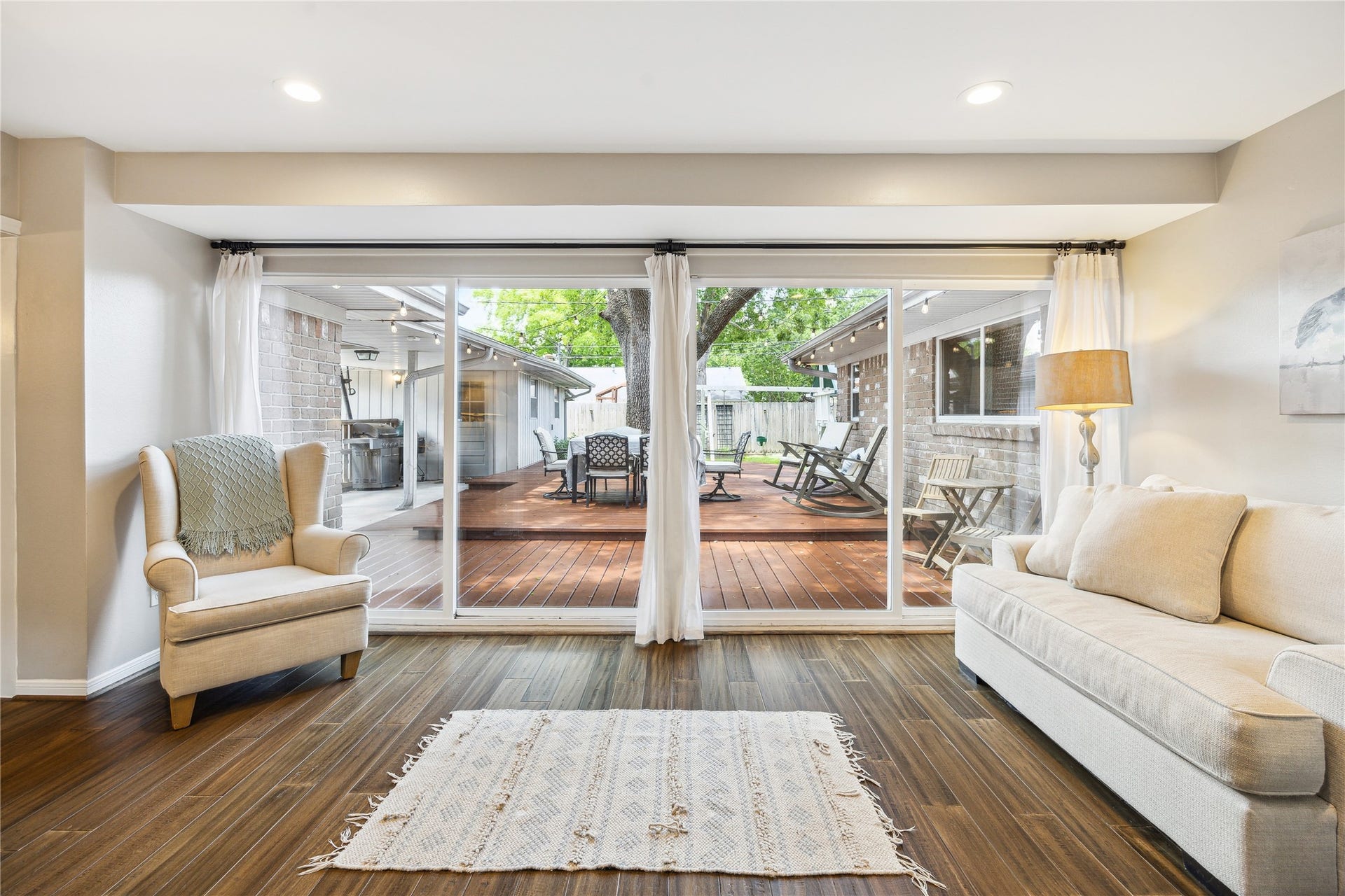10714 Piping Rock Lane, Houston, TX 77042 Glass doors fill the sitting area with natural light and provide direct access to the wood deck.