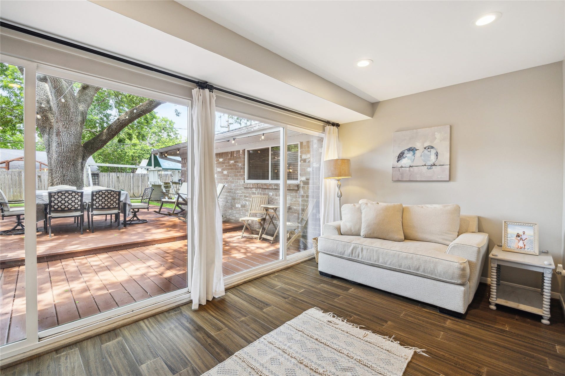 10714 Piping Rock Lane, Houston, TX 77042 Enjoy views of the mature backyard tree and outdoor seating area from this inviting space with wood flooring and recessed lighting.