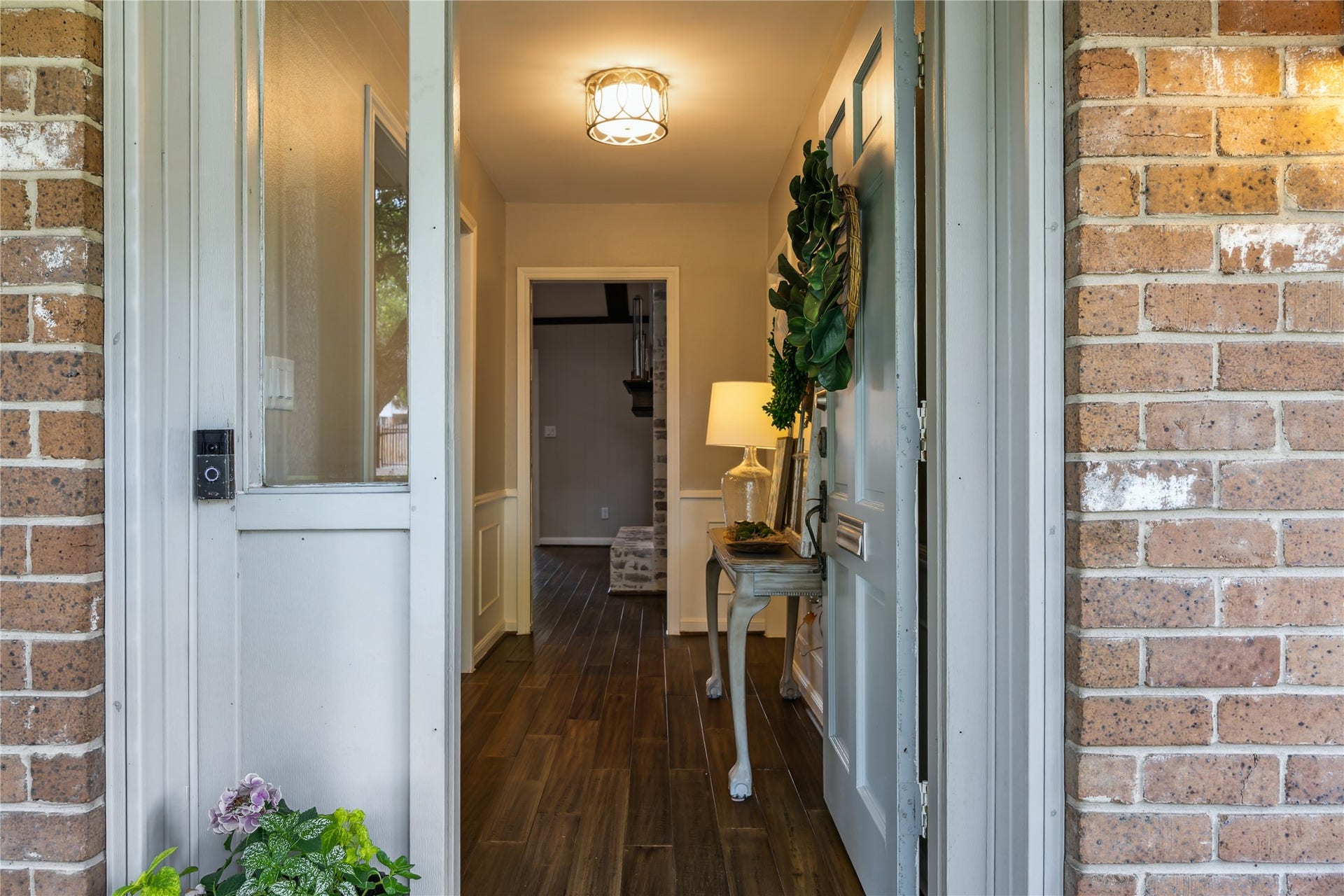 10714 Piping Rock Lane, Houston, TX 77042 Wood flooring and neutral finishes create an inviting entrance, with a wide doorway connecting to the dining room.