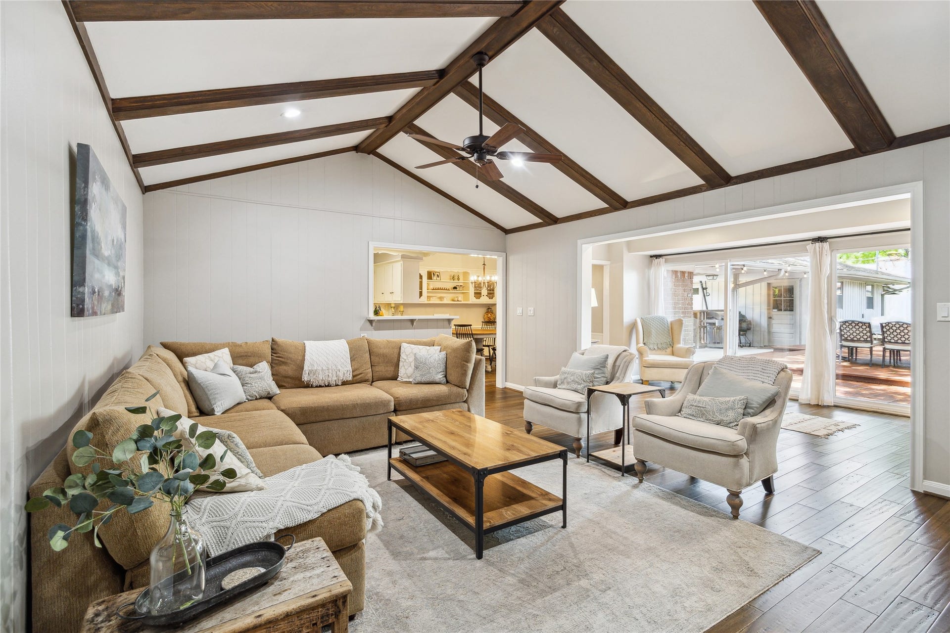 10714 Piping Rock Lane, Houston, TX 77042 Wide openings connect the living room to the kitchen and bright sitting area, creating an easy flow between spaces.