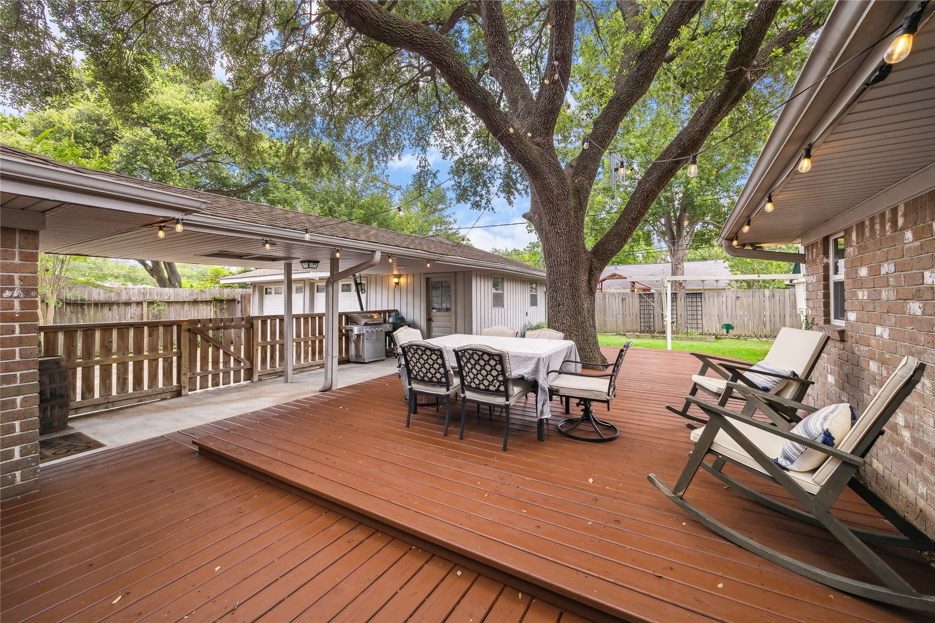 10714 Piping Rock Lane, Houston, TX 77042 The spacious deck connects to a covered walkway, with room for dining, rocking chairs and gatherings under string lights.