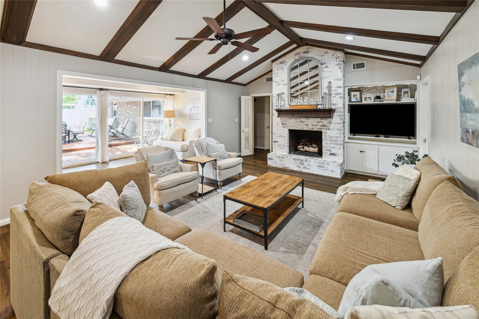 10714 Piping Rock Lane, Houston, TX 77042 The spacious living area offers room for multiple seating arrangements beneath a beamed ceiling, with an adjoining sitting area