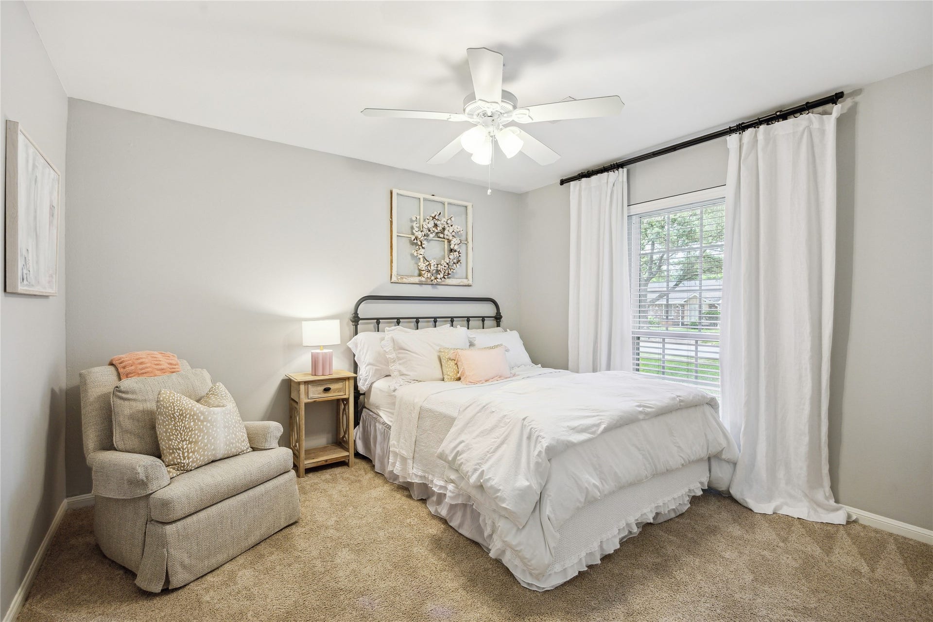 10714 Piping Rock Lane, Houston, TX 77042 Soft neutral colors, natural light and a ceiling fan create a comfortable bedroom with space for a reading chair.