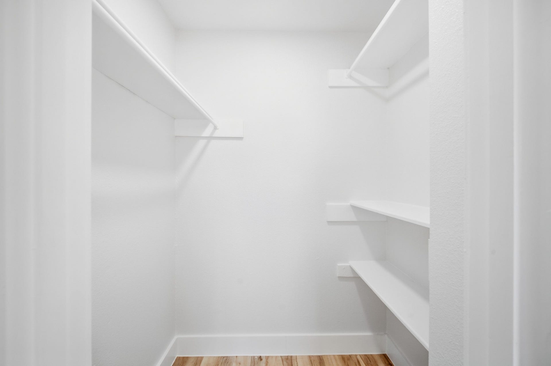 Built-in shelves in the walk-in closet in the secondary bedroom.