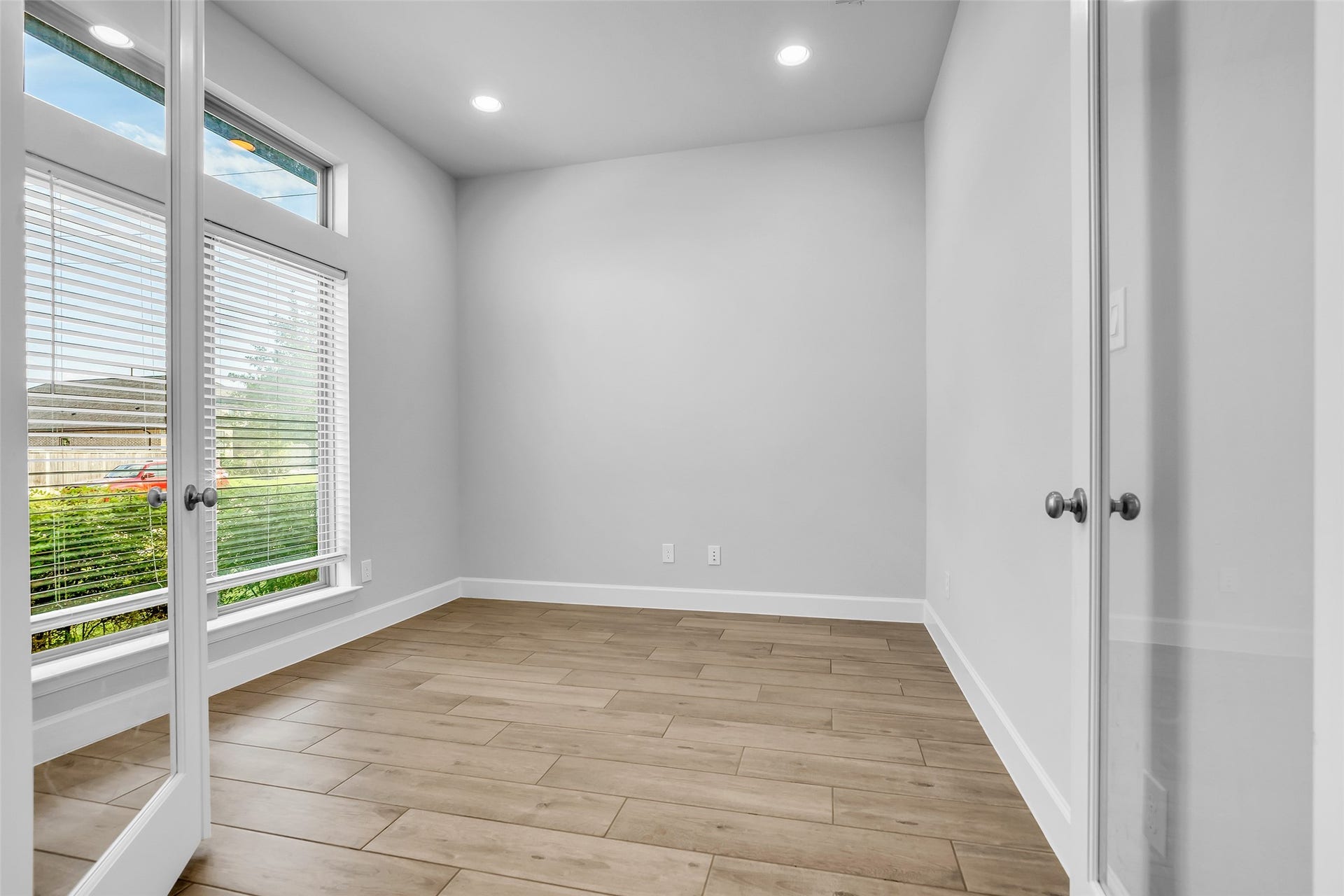 30047 Gold Finch Place, Fulshear, TX 77441 Your Flex Space Is Bright & Inviting w/ Large Windows, Stylish Wood-look Tile, & Elegant Double Doors, Perfect For A Home Office, Gameroom, or Cozy Retreat.