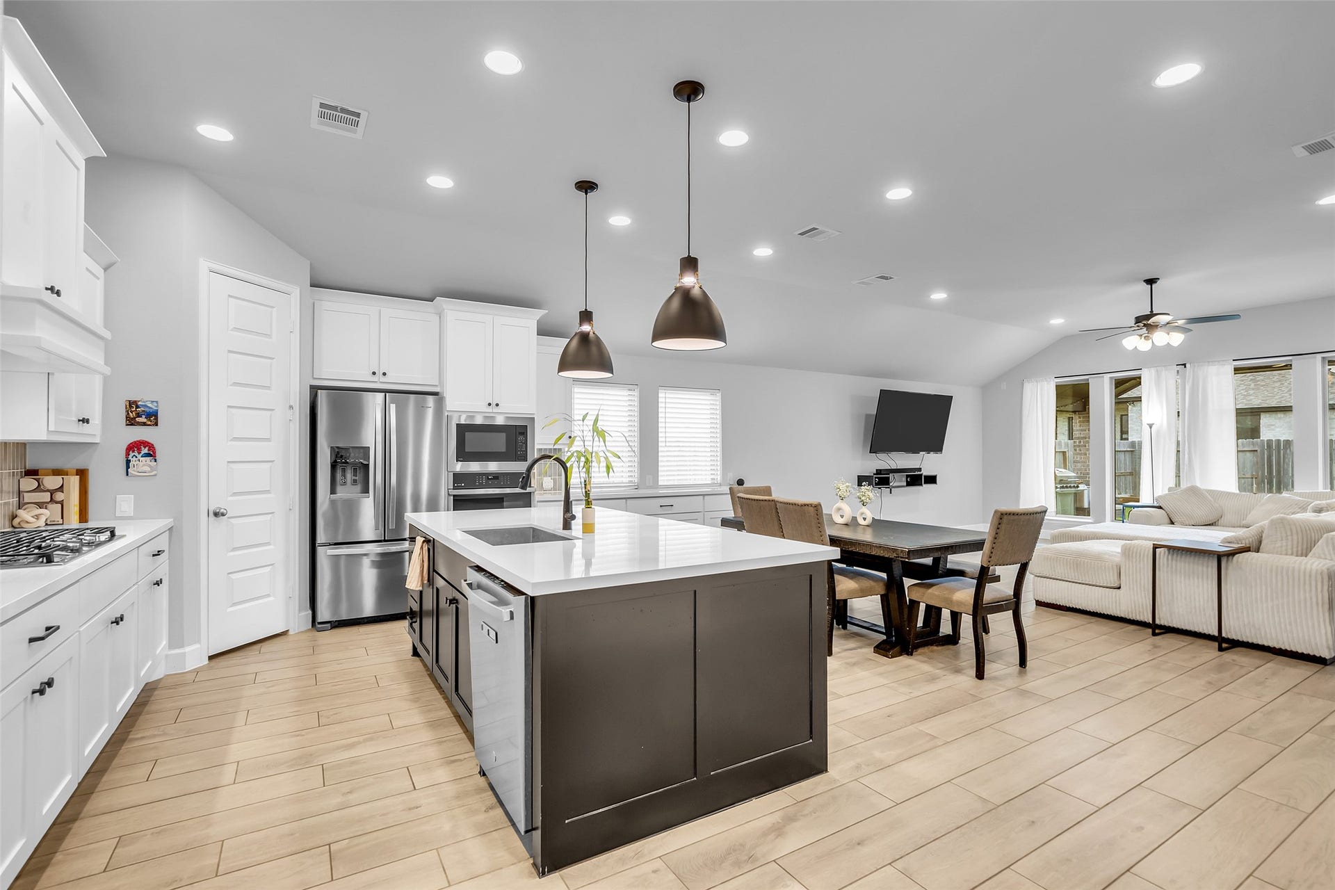 30047 Gold Finch Place, Fulshear, TX 77441 Your Modern, Open-Concept Kitchen & Living Area Features Spacious Island w/ Designer Pendant Lighting, Stainless Steel Appliances, & A Cozy Dining Nook, Seamlessly Flowing Into A Bright, Inviting Living Space w/ Large Windows.