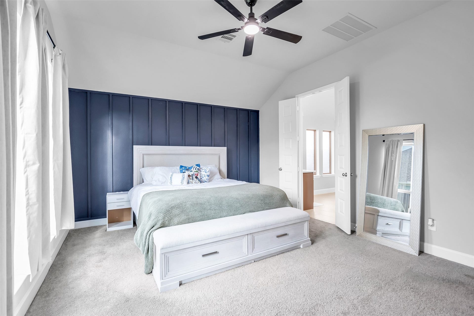 30047 Gold Finch Place, Fulshear, TX 77441 Your Spacious Bedroom Features 8' Doors, Plush Carpeting, & Ceiling Fan, & Lovely Double Doors Leading to Your Primary Bath.