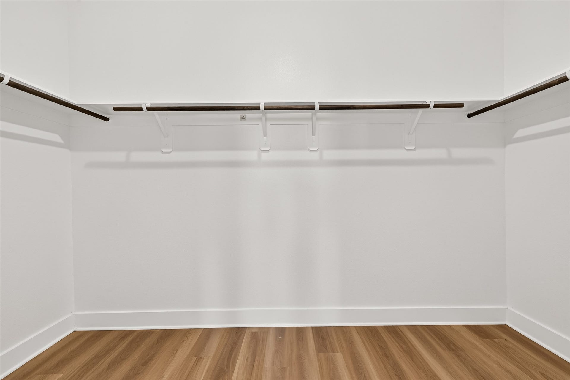 2002 Flatland Drive, Rosenberg, TX 77471 Walk-in closet with hanging rods and shelving on multiple walls.