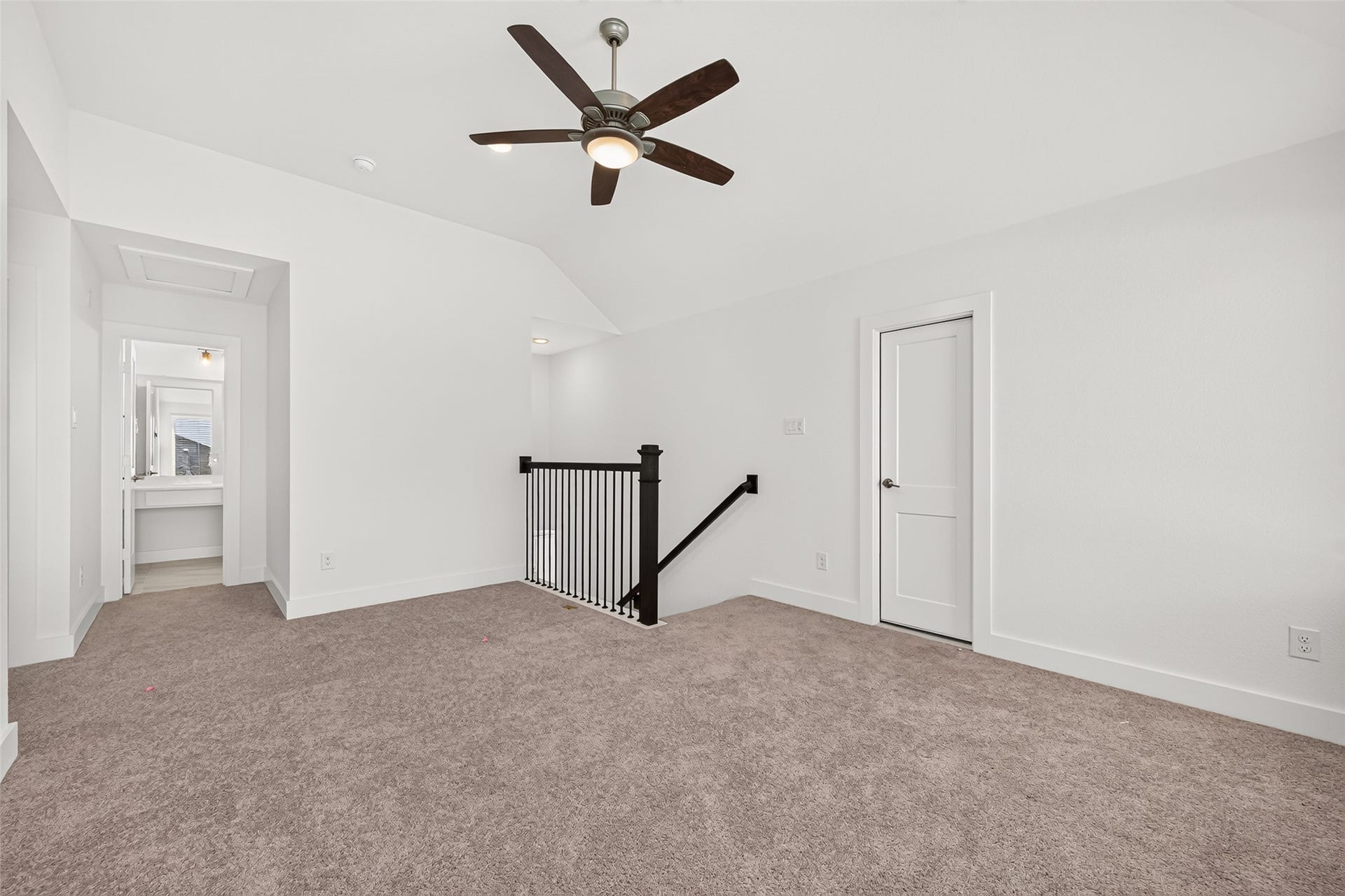 2002 Flatland Drive, Rosenberg, TX 77471 Upstairs loft with carpet and ceiling fan, open to the hallway and secondary bathroom.