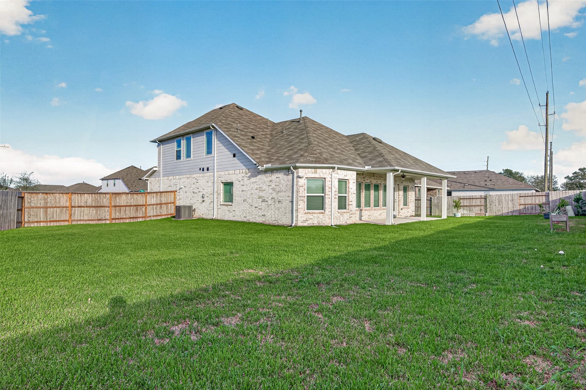 2002 Flatland Drive, Rosenberg, TX 77471 Large fenced backyard with open lawn.