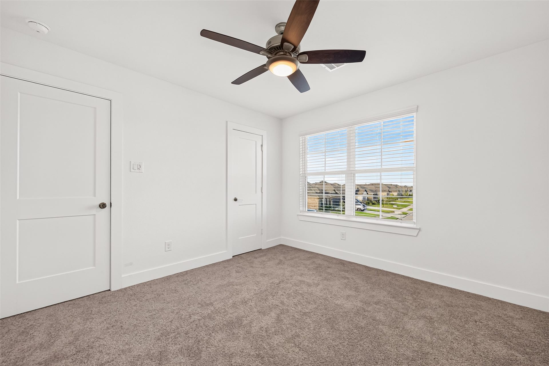 2002 Flatland Drive, Rosenberg, TX 77471 Upstairs bedroom with carpet, ceiling fan, window, and closet.