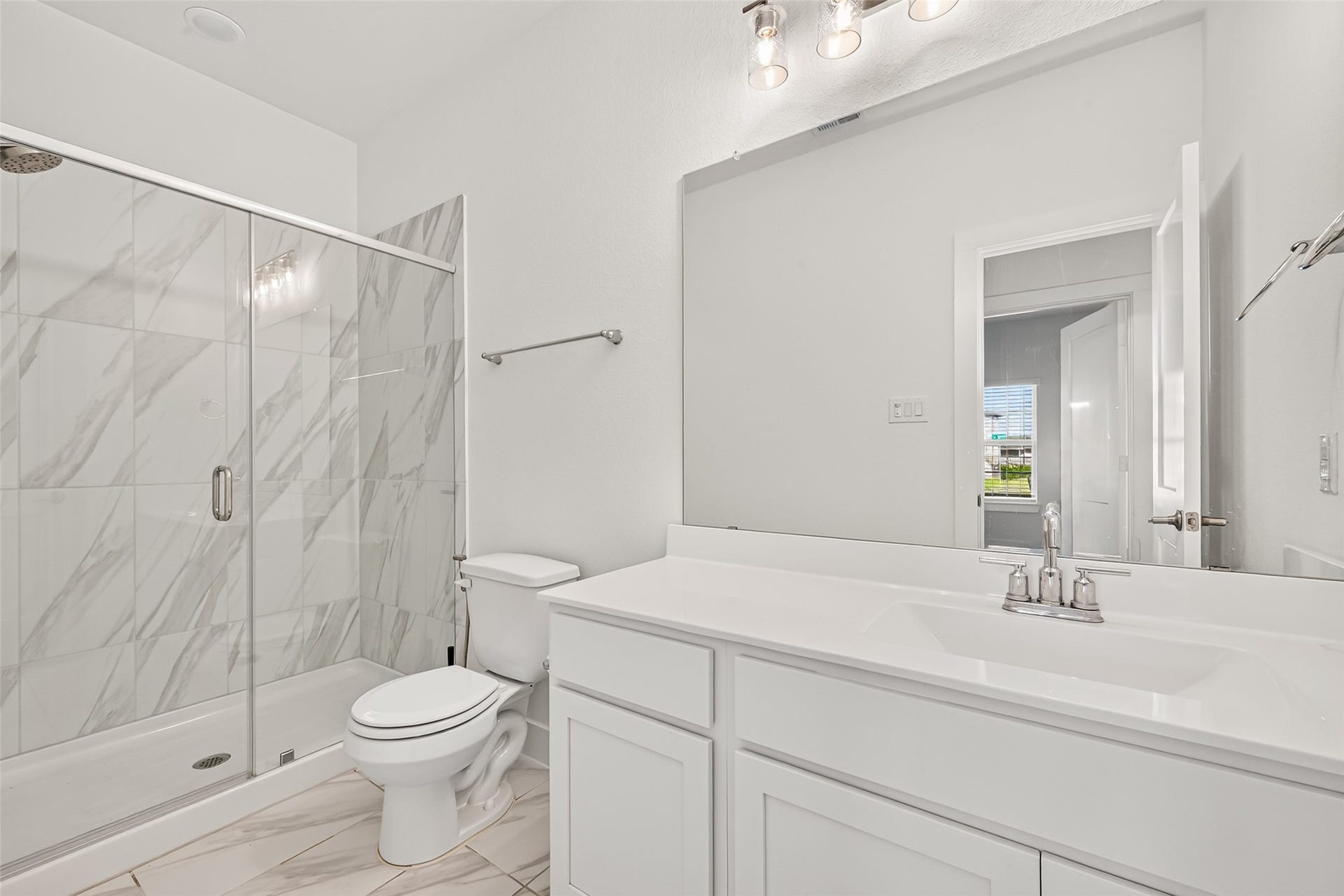 2002 Flatland Drive, Rosenberg, TX 77471 Full bathroom with glass-enclosed shower, marble-look tile, and single vanity.