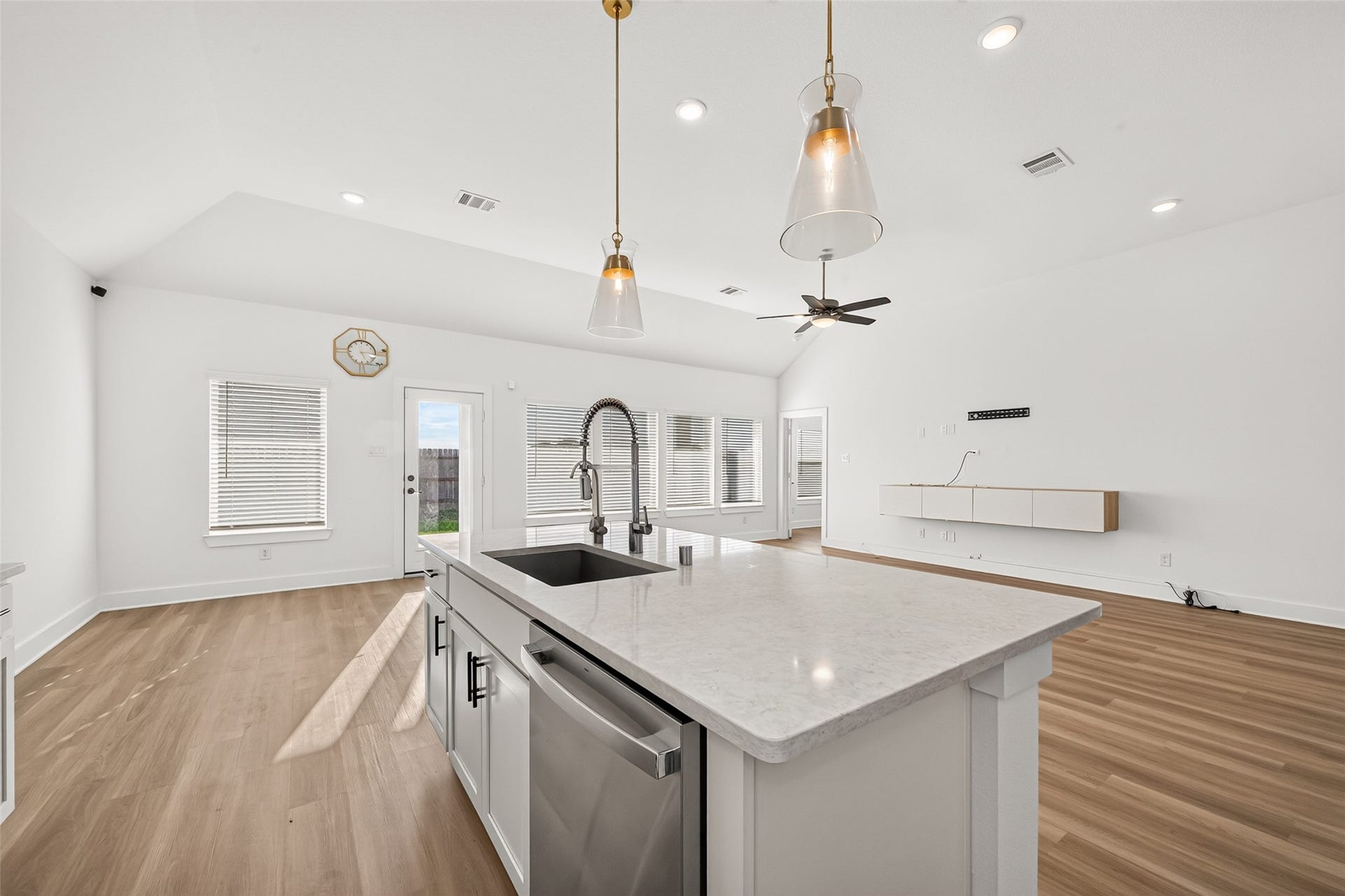 2002 Flatland Drive, Rosenberg, TX 77471 Kitchen island with sink and dishwasher, open to the breakfast area and living room.