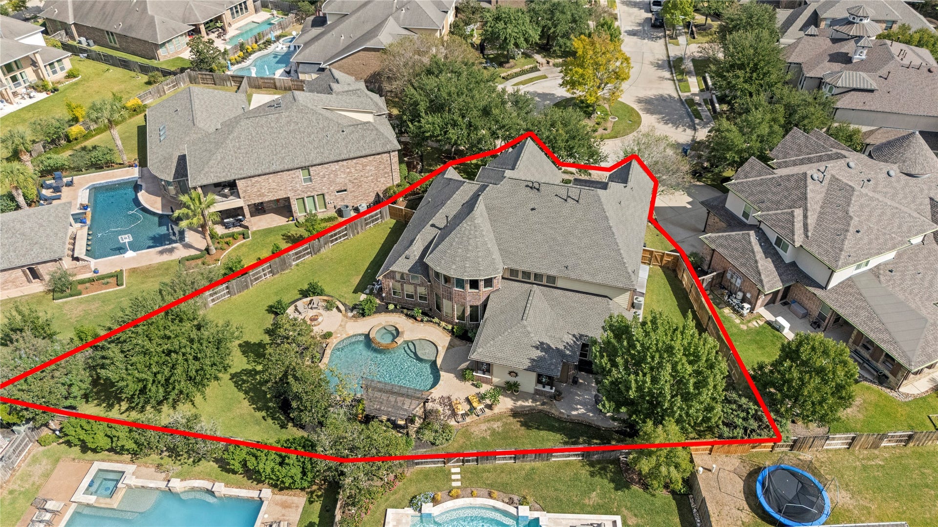 12002 Tall Haven Lane, Cypress, TX 77433 Aerial view outlining the property's lot and showcasing the spacious backyard, swimming pool, and outdoor living areas.