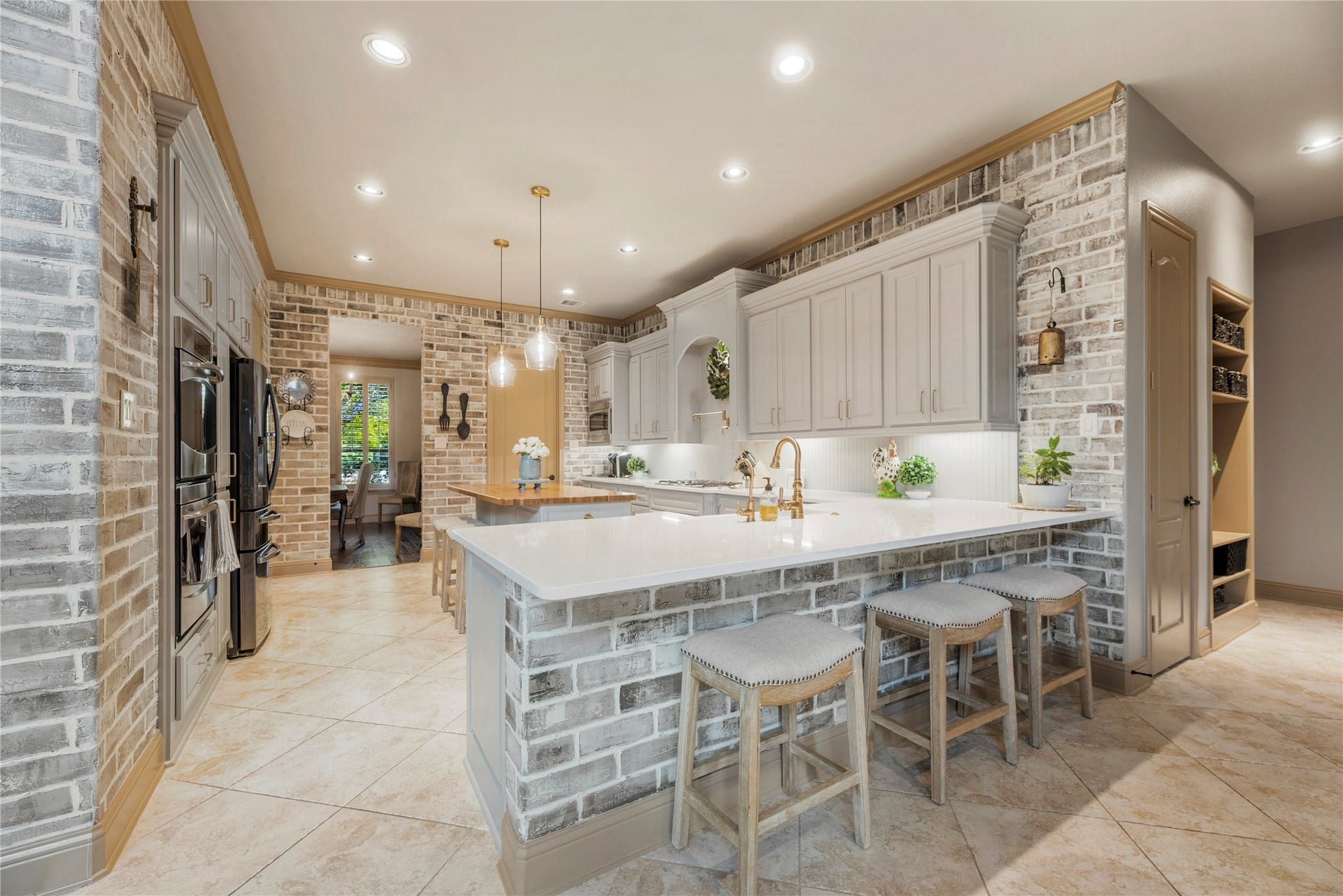 12002 Tall Haven Lane, Cypress, TX 77433 Beautiful kitchen with a large center island, custom cabinetry, and an open layout ideal for cooking and gathering.