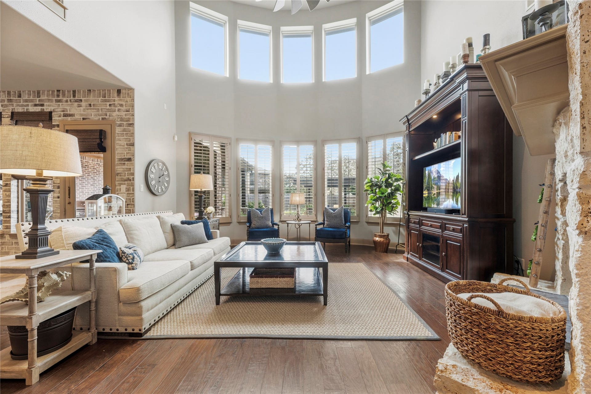 12002 Tall Haven Lane, Cypress, TX 77433 Stunning living room featuring soaring ceilings, expansive windows, and a beautiful fireplace.