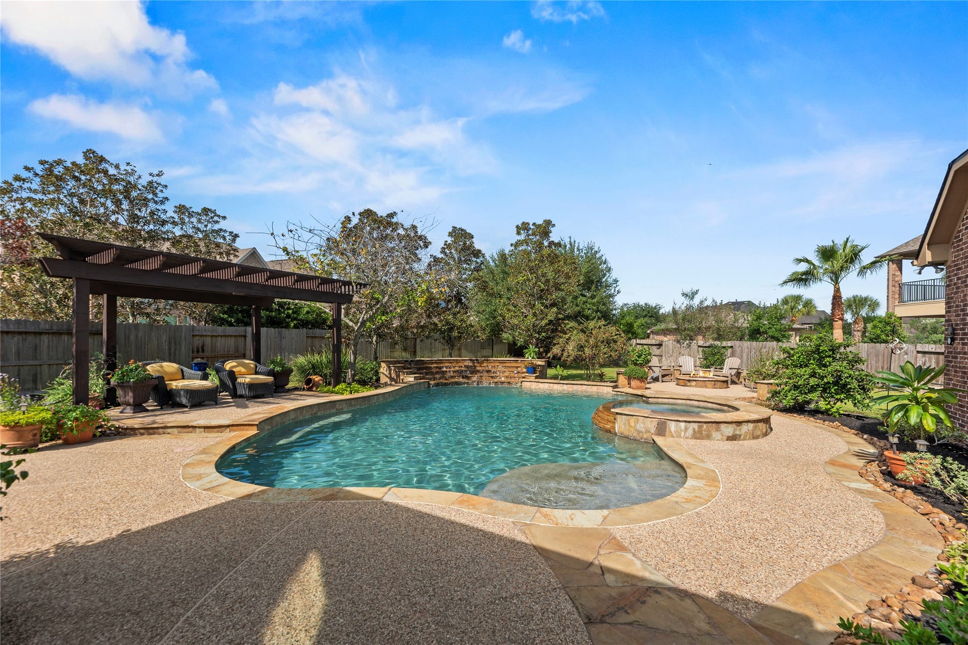 12002 Tall Haven Lane, Cypress, TX 77433 Beautiful backyard oasis featuring a sparkling swimming pool and spacious patio area for relaxing or entertaining.
