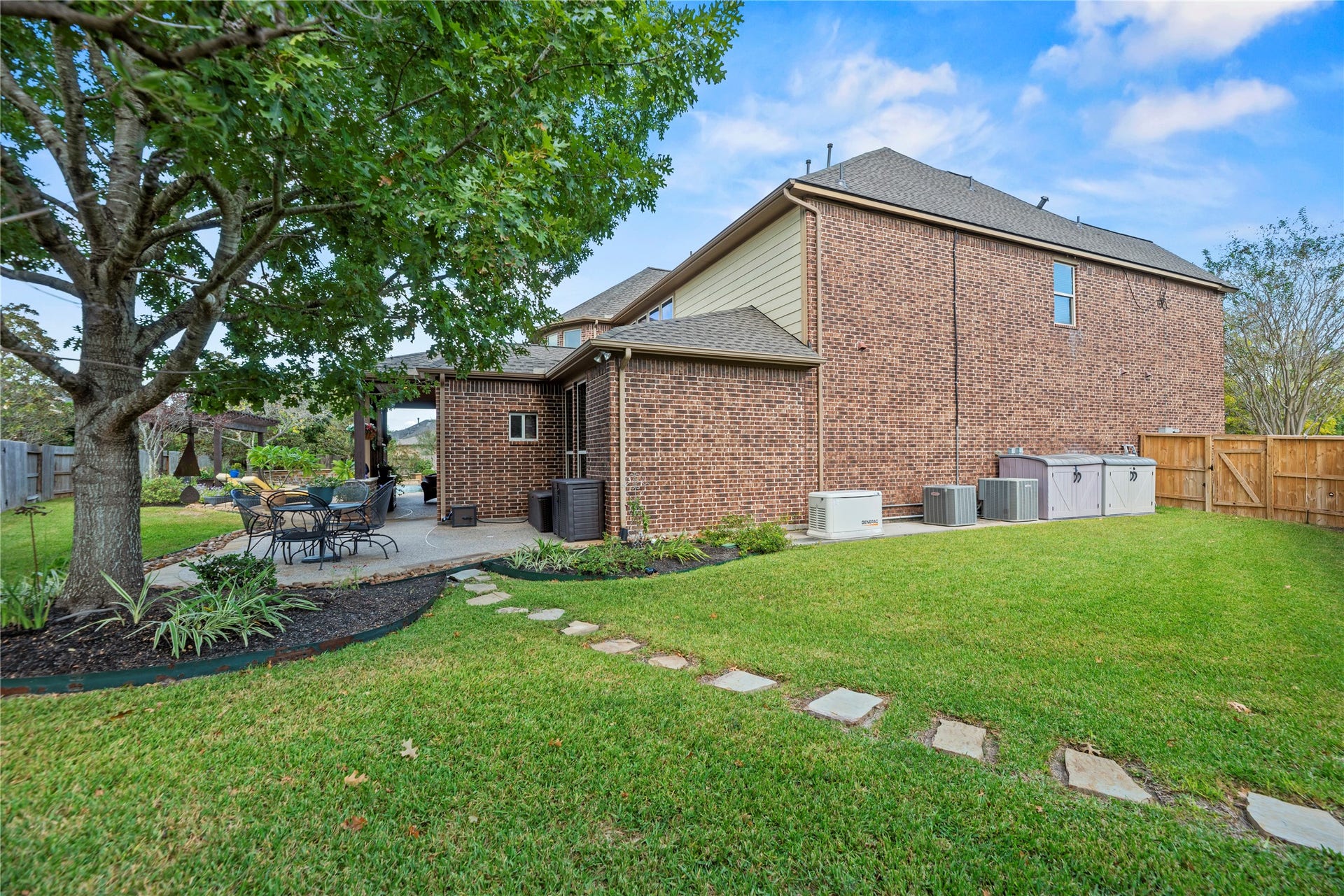 12002 Tall Haven Lane, Cypress, TX 77433 Another view of the backyard, showcasing the spacious lawn and mature trees.
