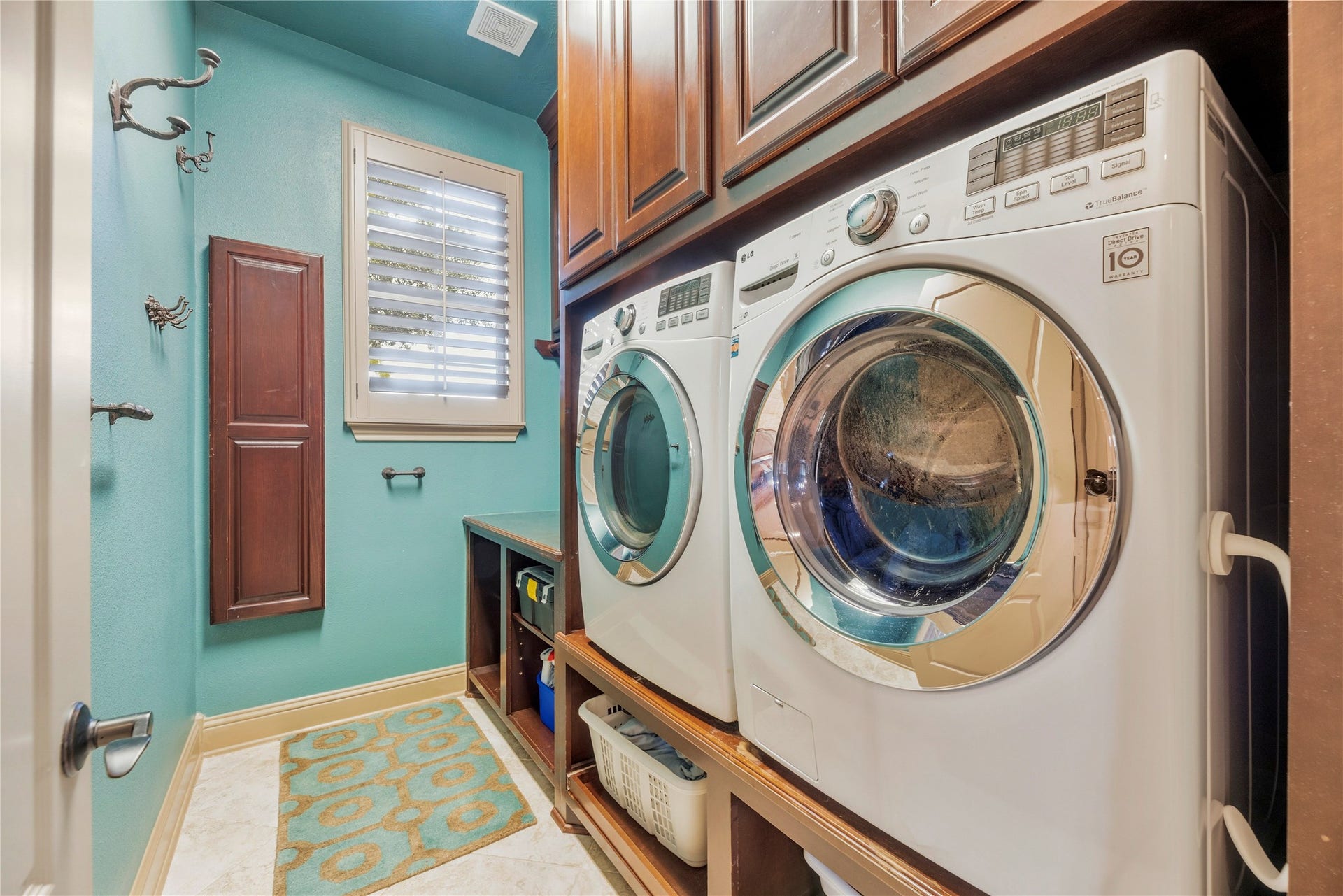 12002 Tall Haven Lane, Cypress, TX 77433 Laundry room featuring built-in cabinetry, counter space, and plenty of storage for everyday essentials.