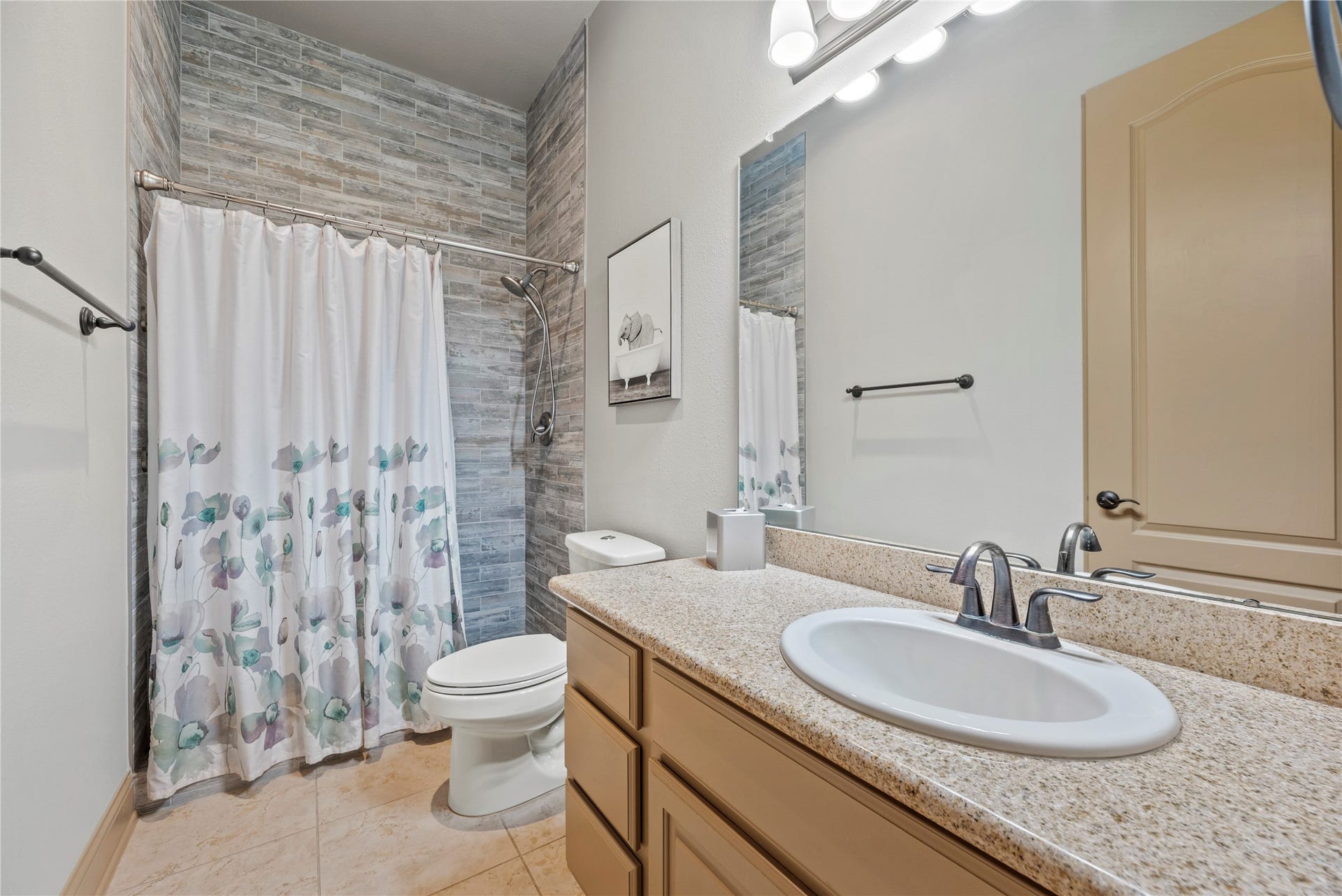 12002 Tall Haven Lane, Cypress, TX 77433 Secondary downstairs bathroom featuring a spacious vanity, decorative tile accents, and a shower.