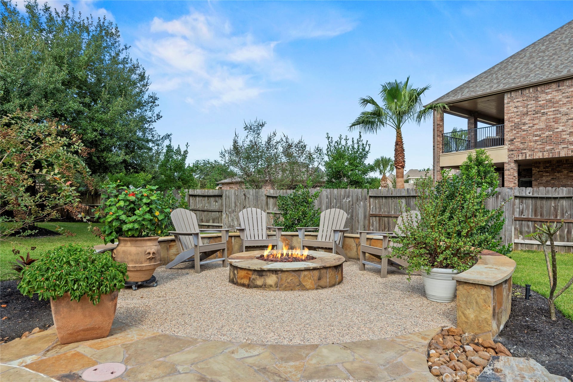 12002 Tall Haven Lane, Cypress, TX 77433 Inviting outdoor courtyard with a beautiful fireplace.