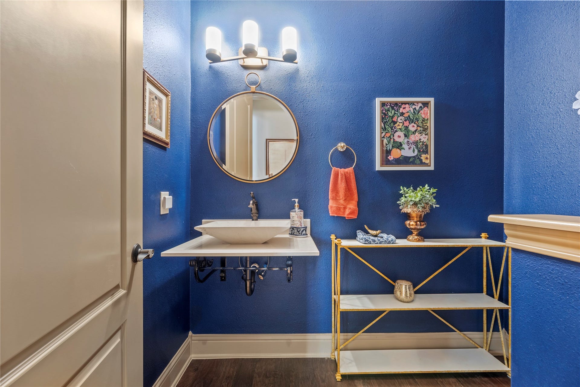12002 Tall Haven Lane, Cypress, TX 77433 Stylish half bathroom featuring bold blue walls, a spacious vanity, and unique decorative details.